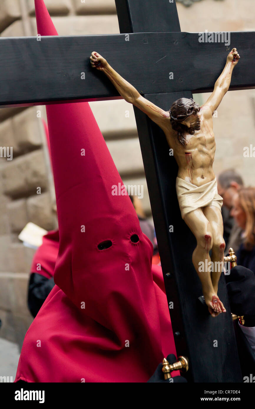 Penitent with a cross at the Good Friday procession, Semana Santa, Holy Week, Barcelona, Catalonia, Spain, Europe Stock Photo