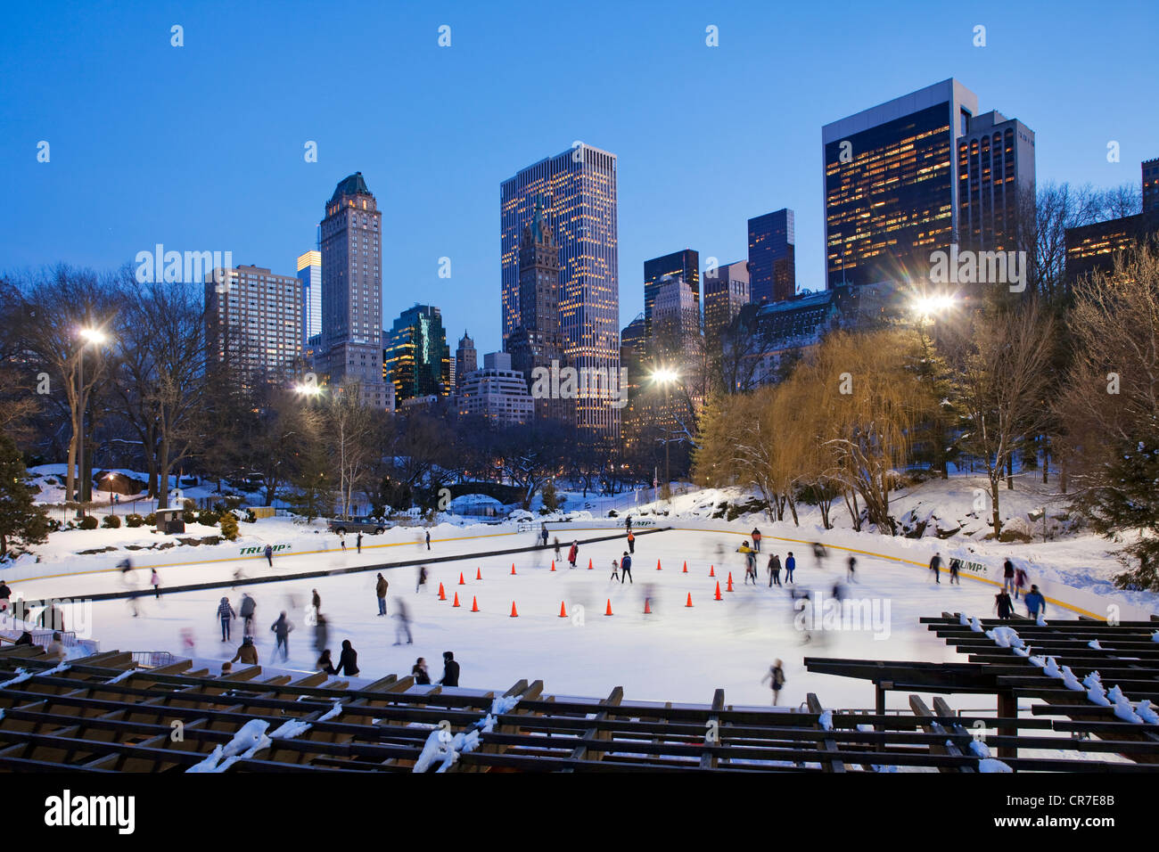 United States, New York City, Manhattan, Central Park in winter under the snow, ice rink Wollman Rink and the towers of Midtown Stock Photo