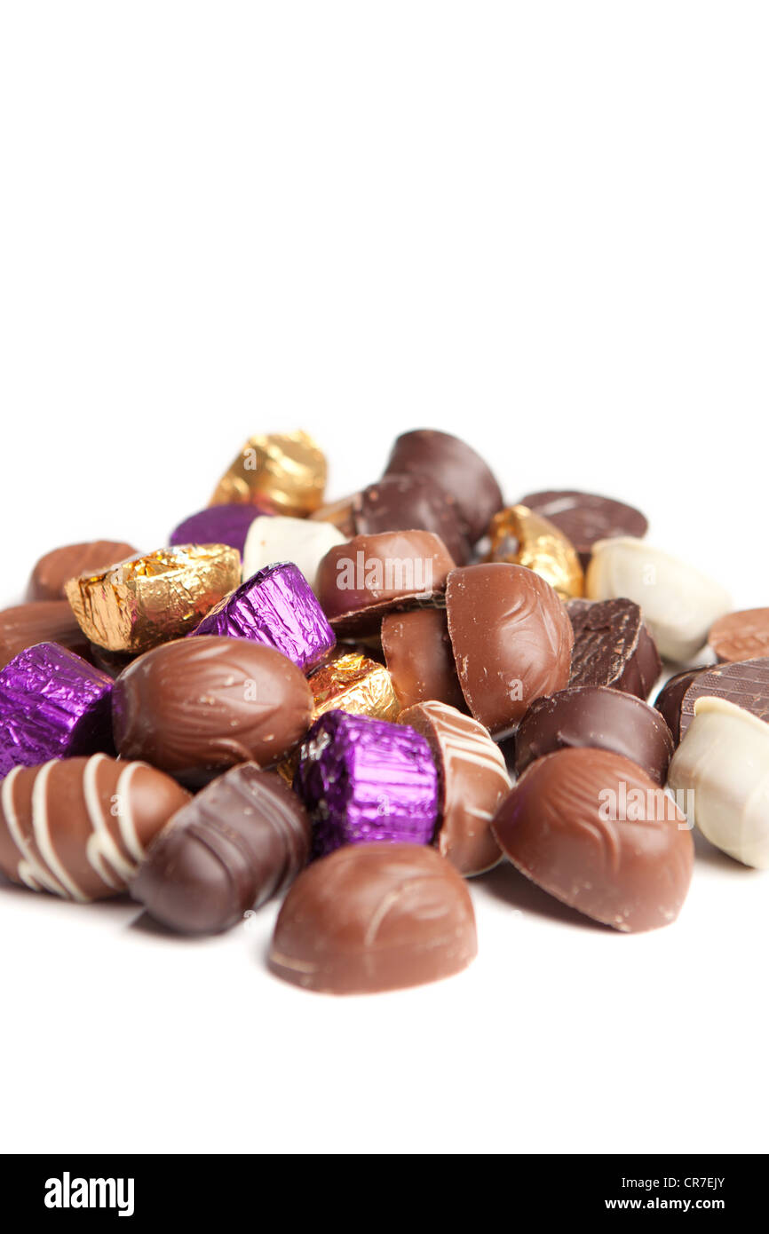 A selection of chocolates in an untidy pile against a white background Stock Photo