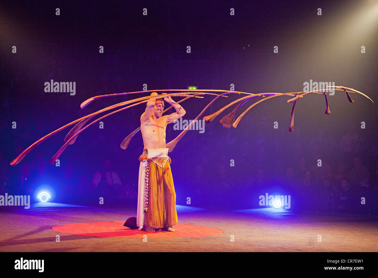 Balancing act where the Swiss performer Rigolo uses 13 palm branches to create a light suspended sculpture Stock Photo