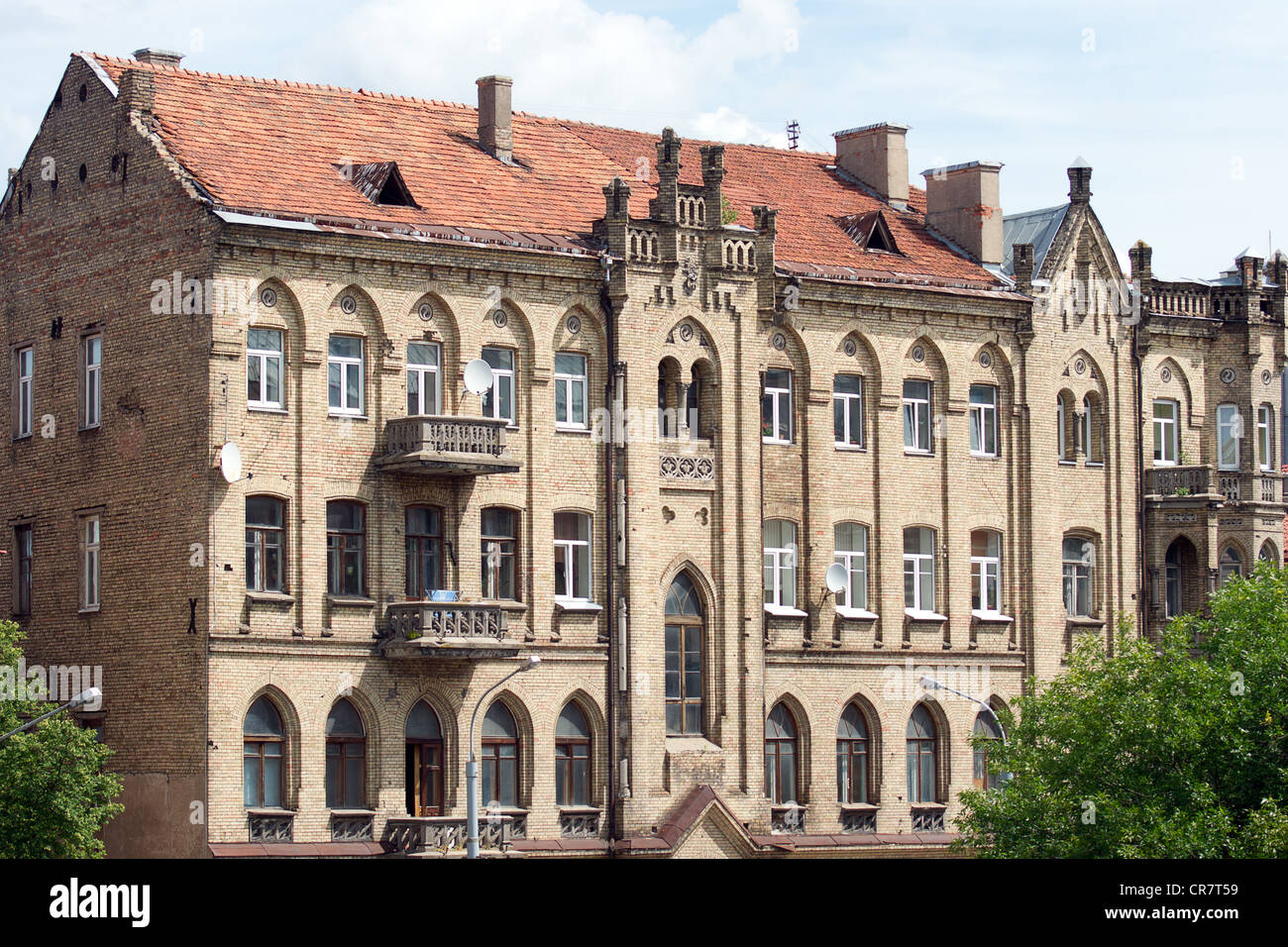 The facade of the old multi-story brick house in Vilnius, Lithuania Stock Photo