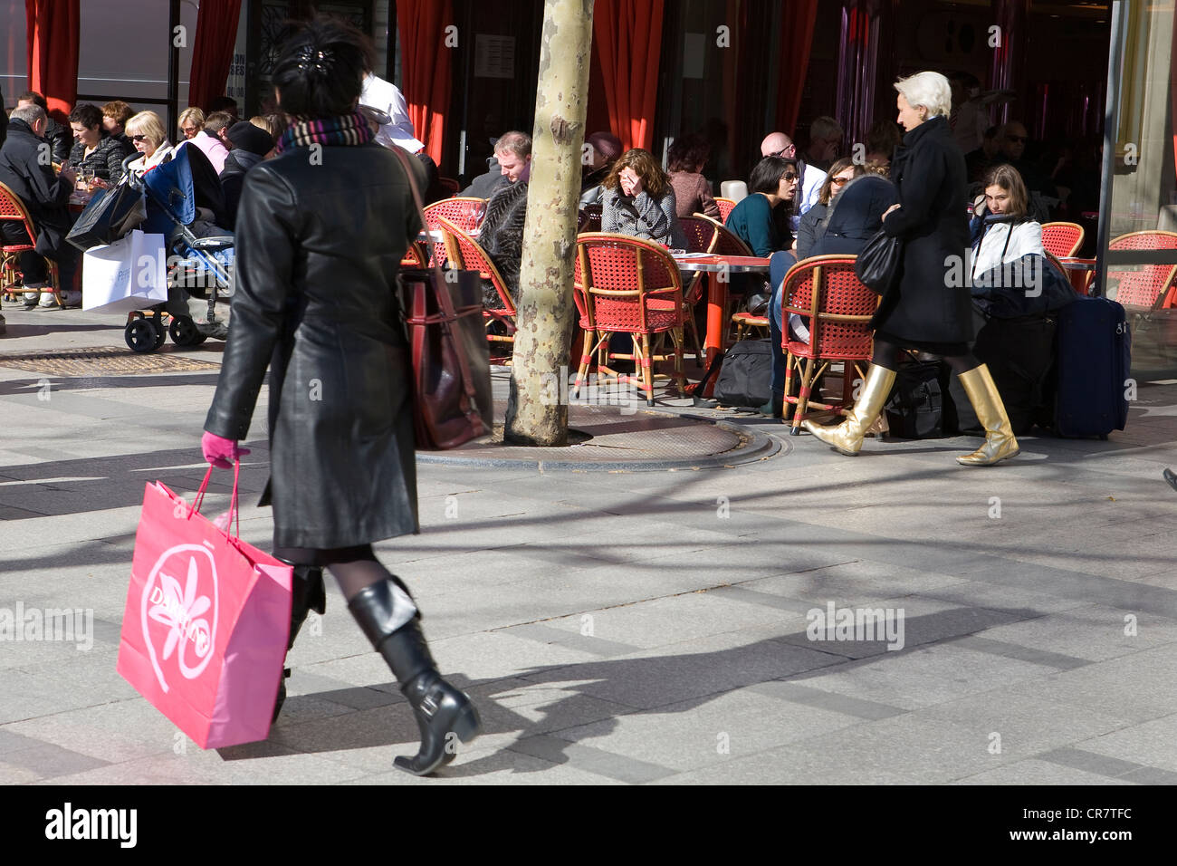 France, Paris, Avenue des Champs Elysees, pedestrian from the back in front of the terrace of a cafe Stock Photo