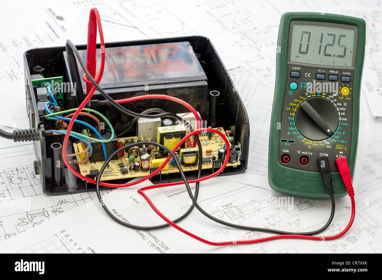 Testing old battery voltage with digital multimeter Stock Photo