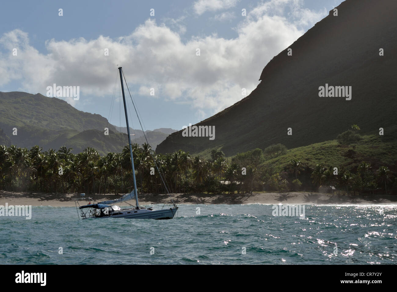 Yacht anchored in Baie Haavei (bay has several other names), rolly anchorage on SW corner of Ua Huka, Marquesas Islands, Pacific Stock Photo