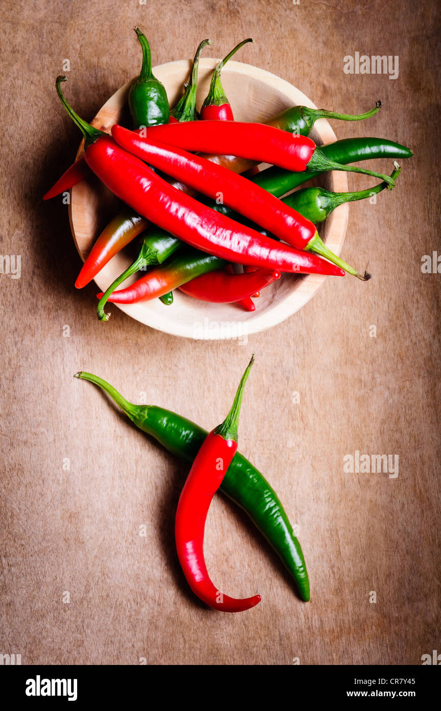 Red and green hot chili peppers on a vintage wooden background Stock Photo