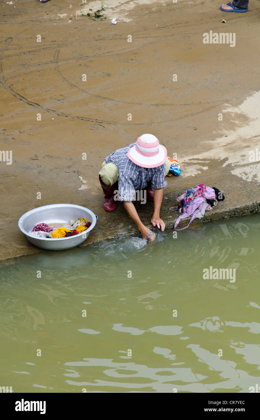 A Vietnamese washing clothes at the river in Hoi An Vietnam Stock Photo Alamy