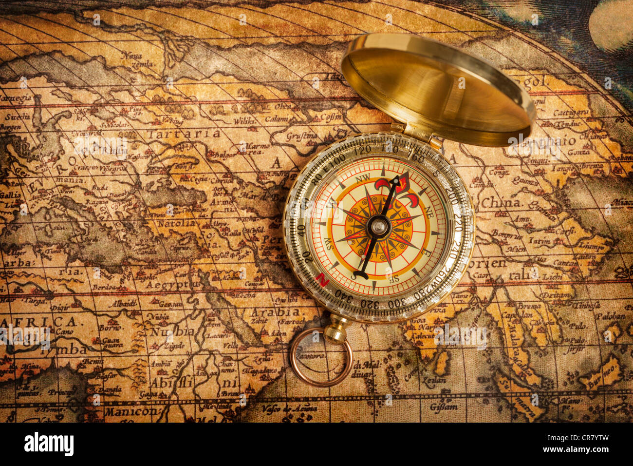 Old vintage retro golden compass on ancient map Stock Photo