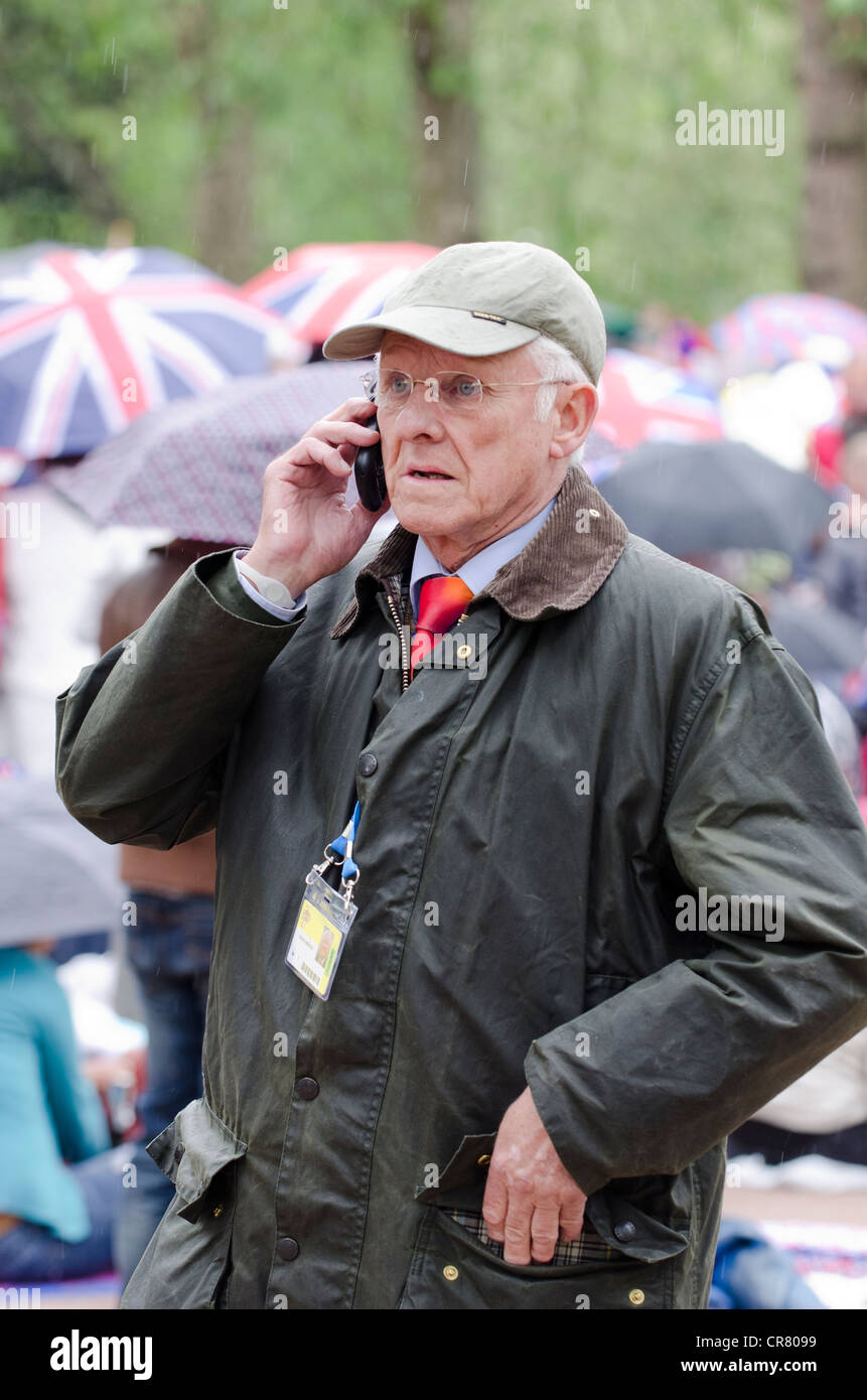 Dickie Arbiter,  takes a call The Queen's Diamond Jubilee Celebrations Revelers waiting for  pop concert in The Mall Stock Photo