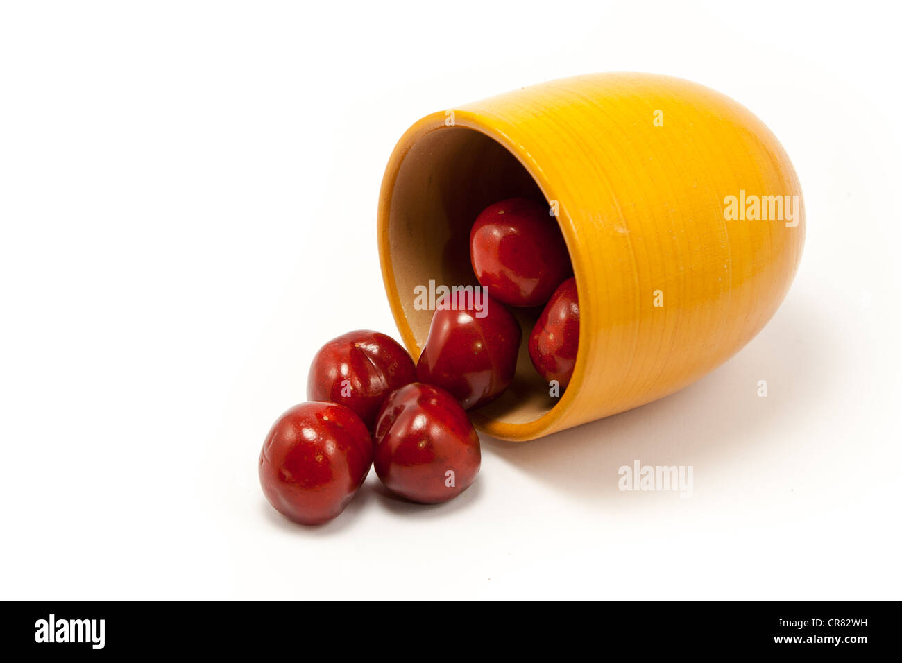 Juicy ruby red cherries in an orange cup Stock Photo Alamy
