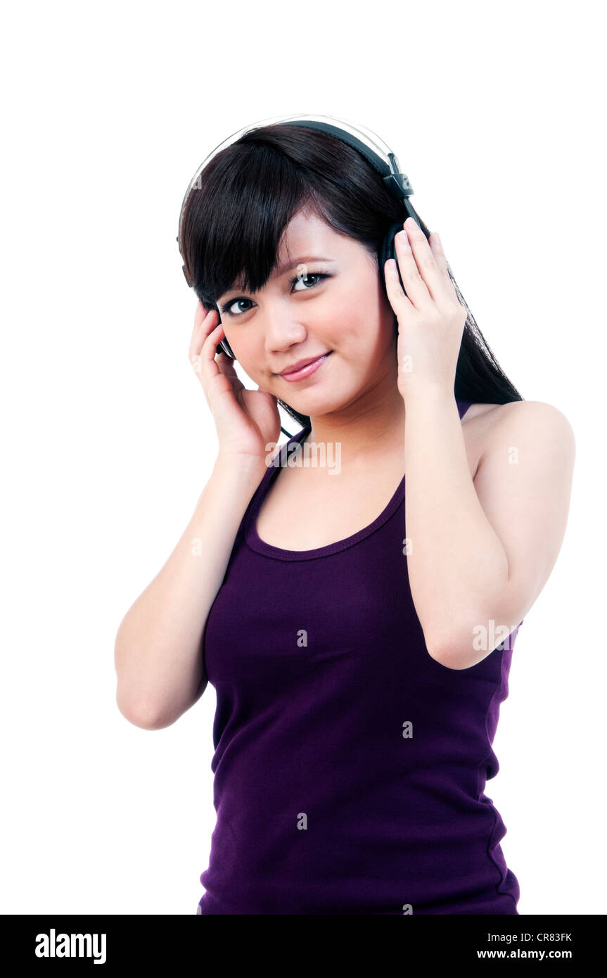 Attractive young Asian woman listening to music, portrait Stock Photo ...