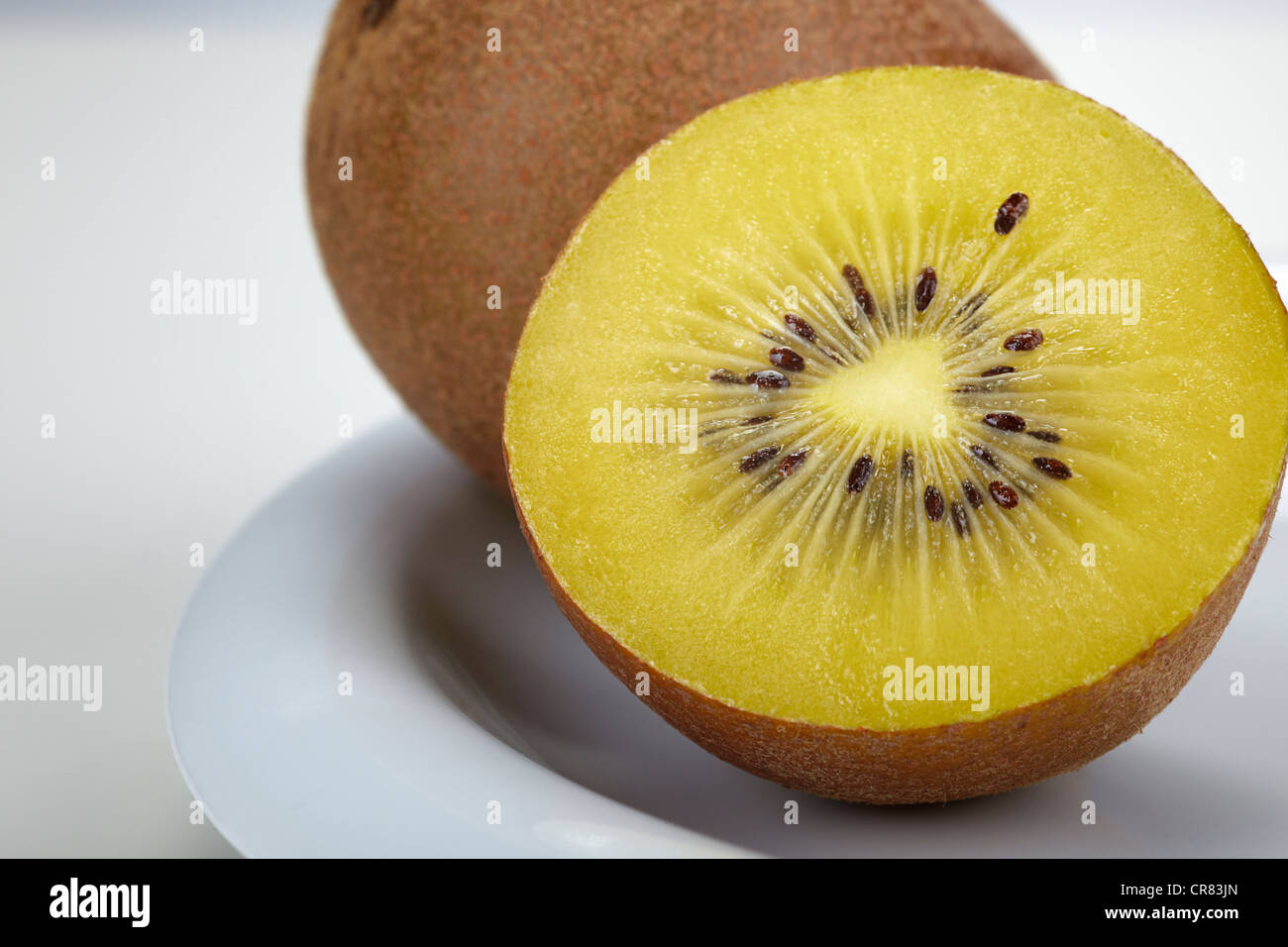 Kiwifruit (Actinidia deliciosa) on a white plate Stock Photo
