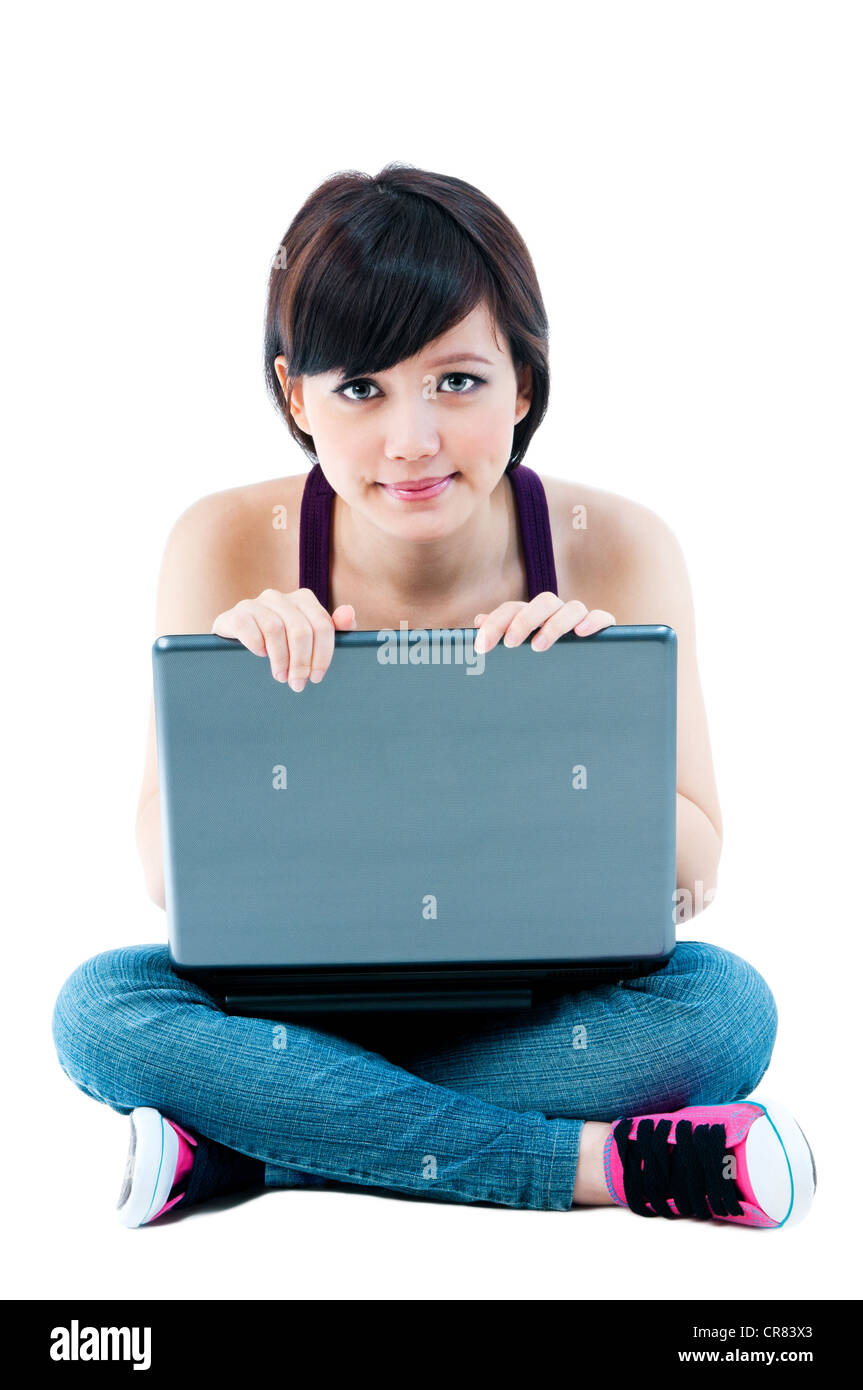 Cute young woman sitting on floor with laptop Stock Photo - Alamy