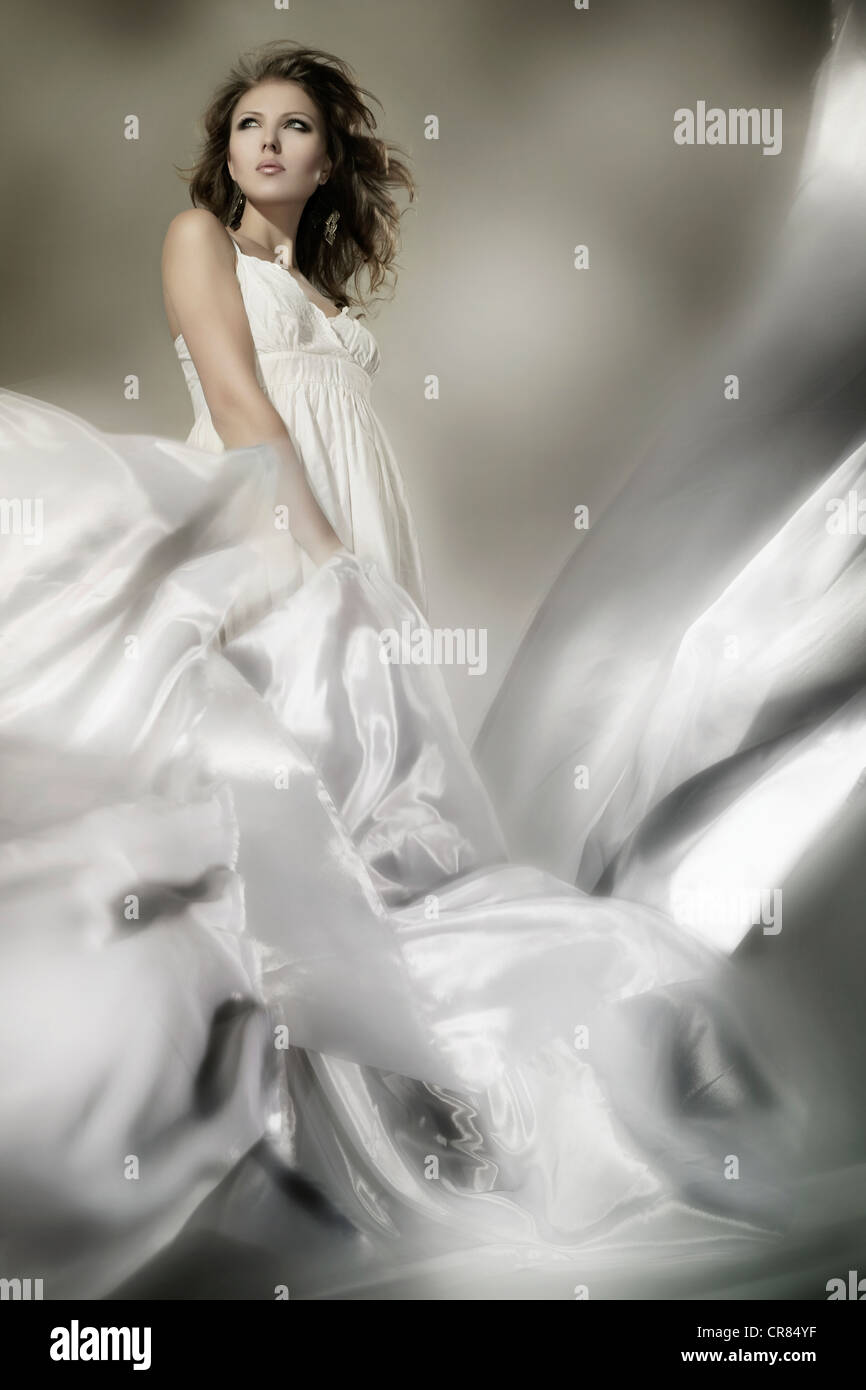 Young woman wearing a white dress with billowing fabric, fashion Stock  Photo - Alamy