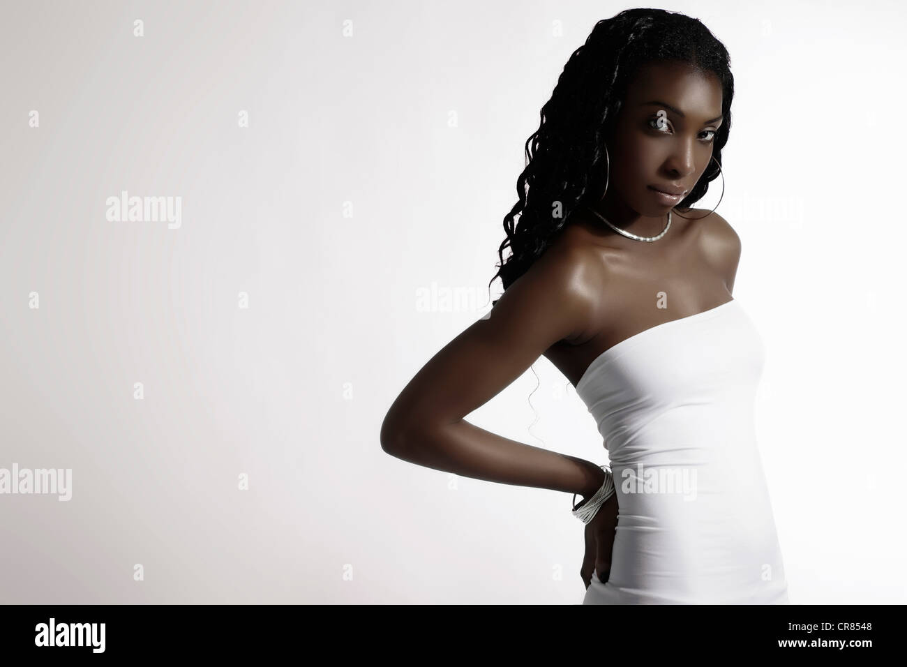 Young Dark Skinned Woman Wearing A White Dress Fashion Stock