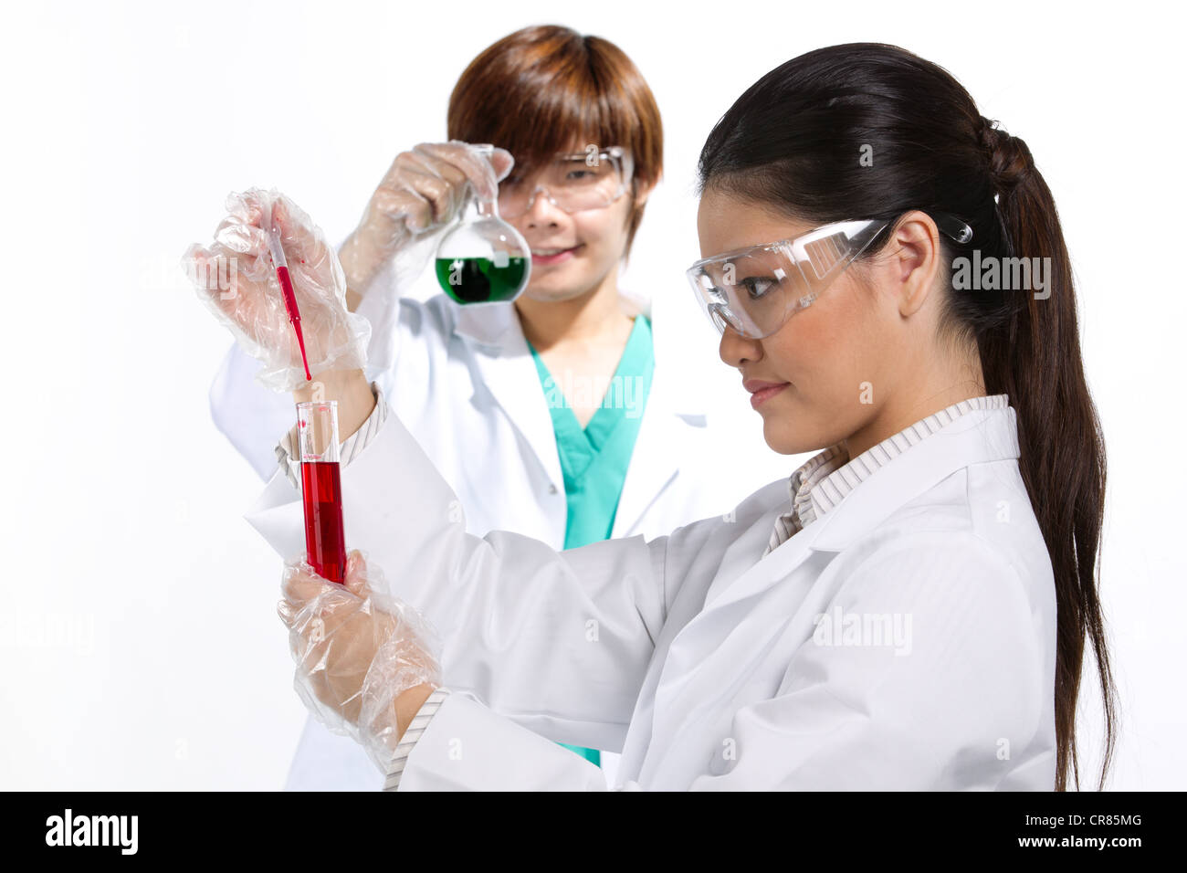 Two scientists analyzing solution. Stock Photo