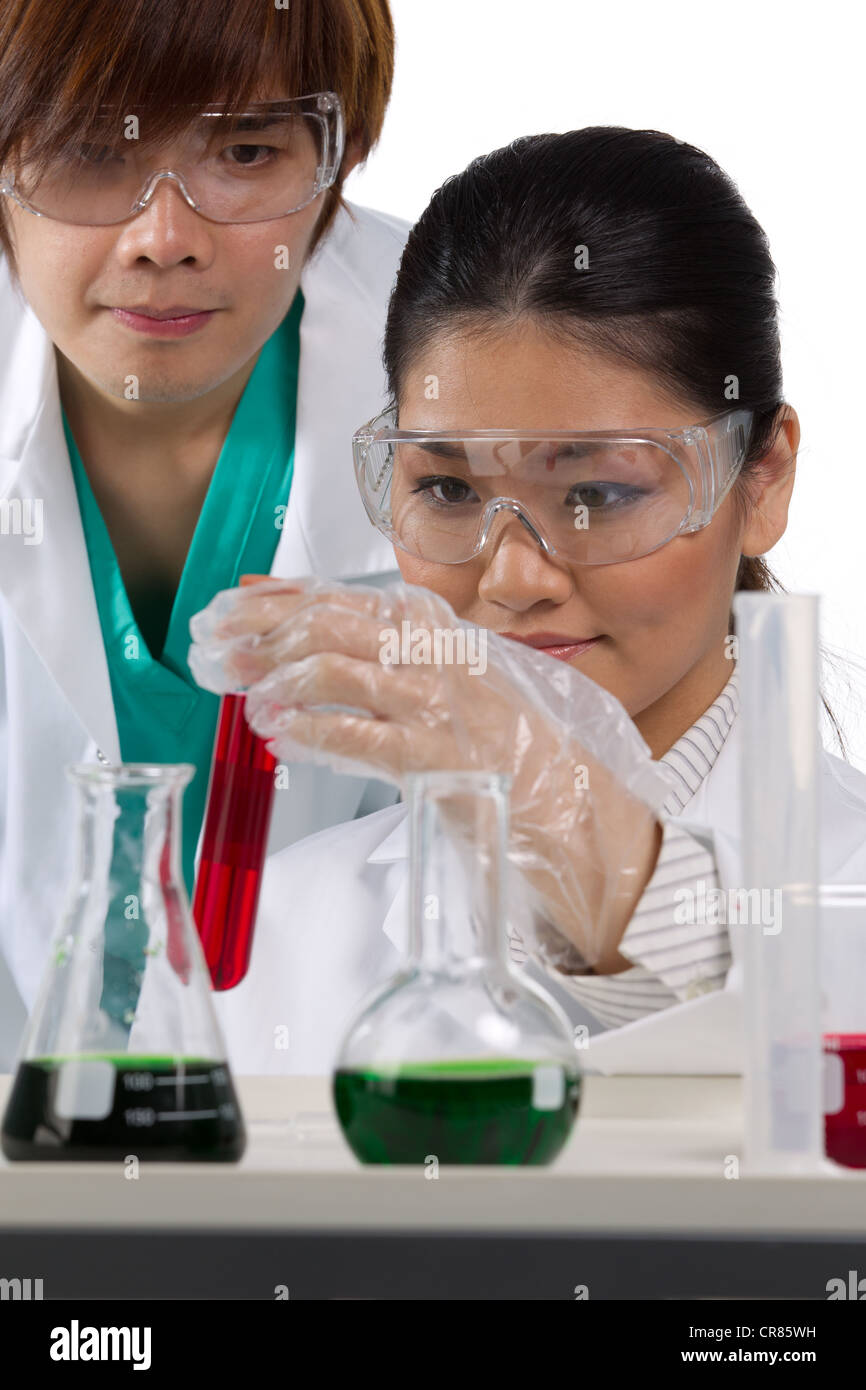 Two scientists analyzing solution. Stock Photo