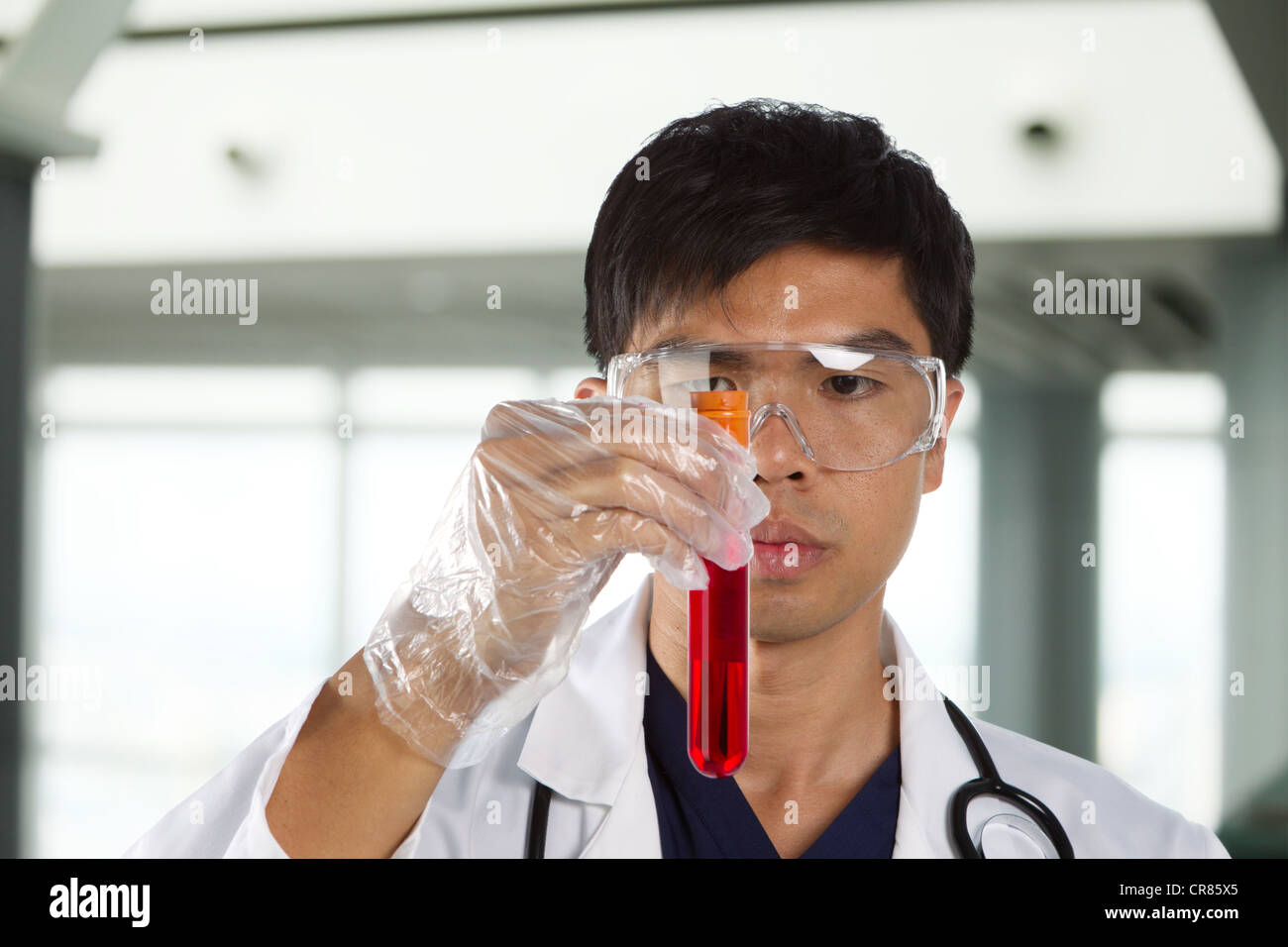 Portrait of scientist analyzing a solution. Stock Photo