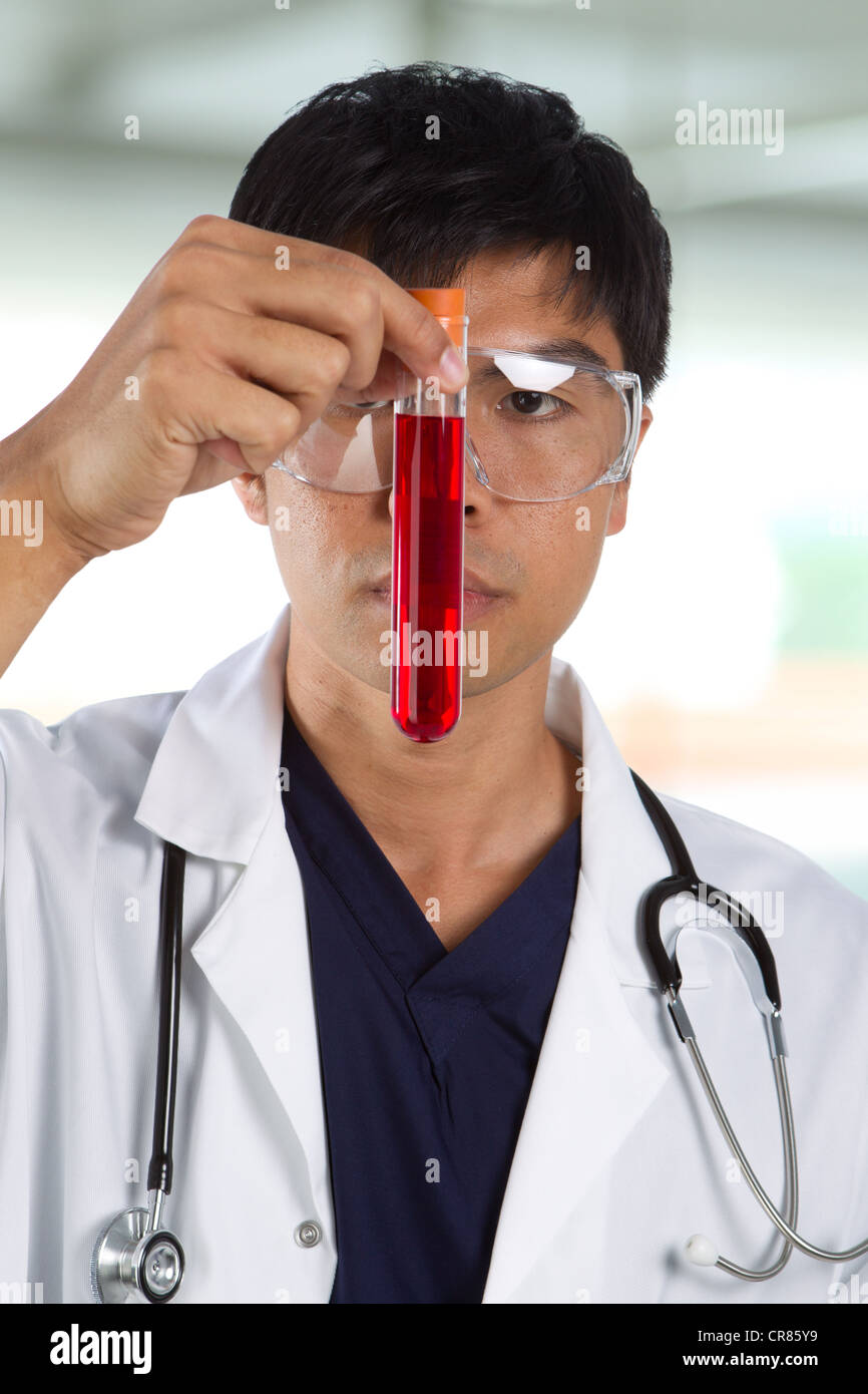 Portrait of scientist analyzing a solution. Stock Photo