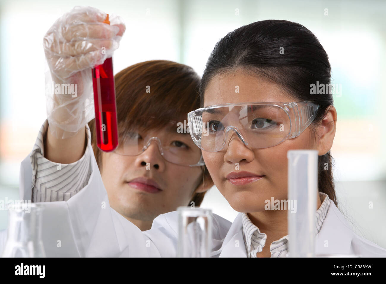 Scientific researchers looking at a liquid solution. Stock Photo