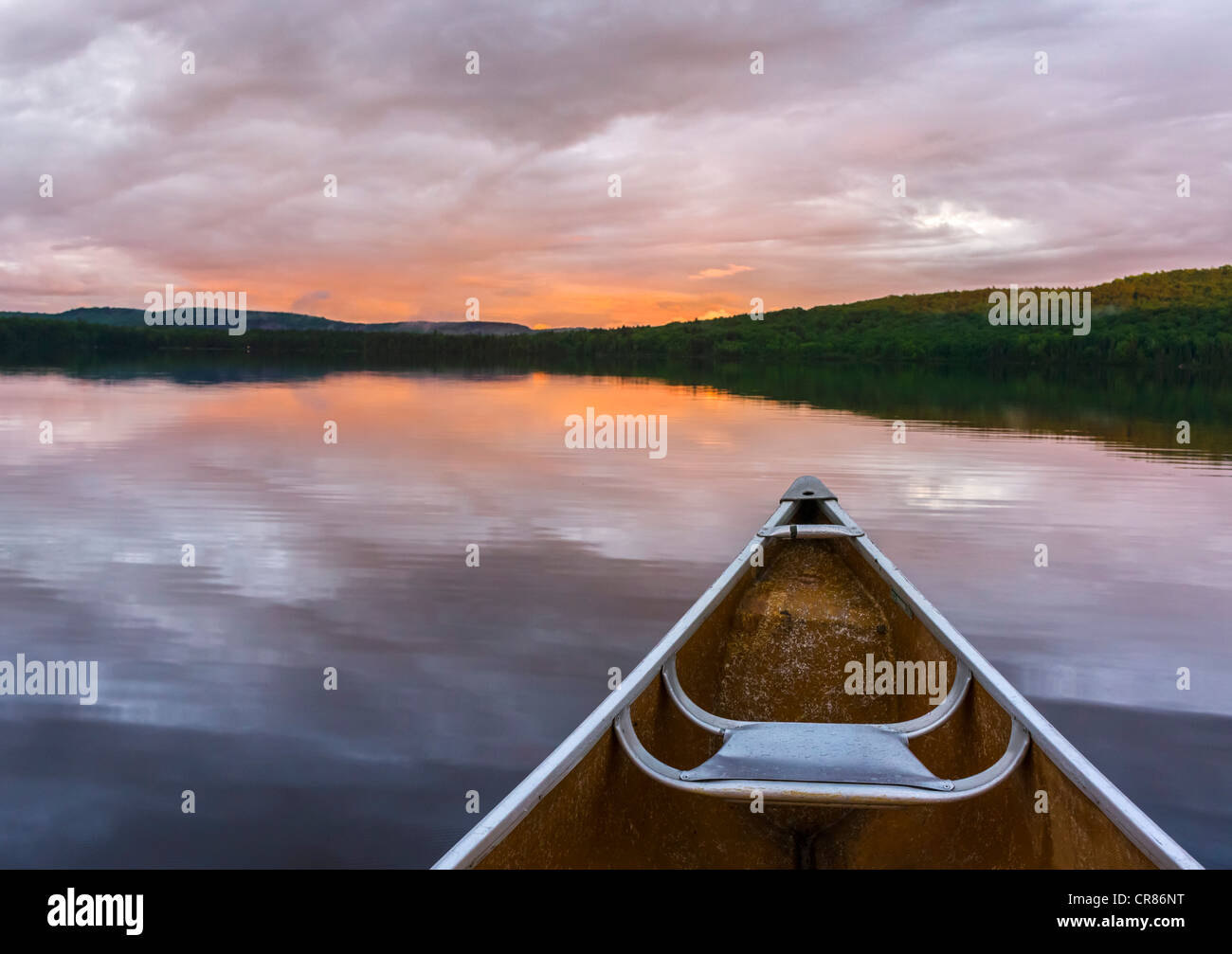 Canoeing on lake at sunset at the Killarney Lodge resort, Lake of Two Rivers, Algonquin Provincial Park, Ontario, Canada Stock Photo
