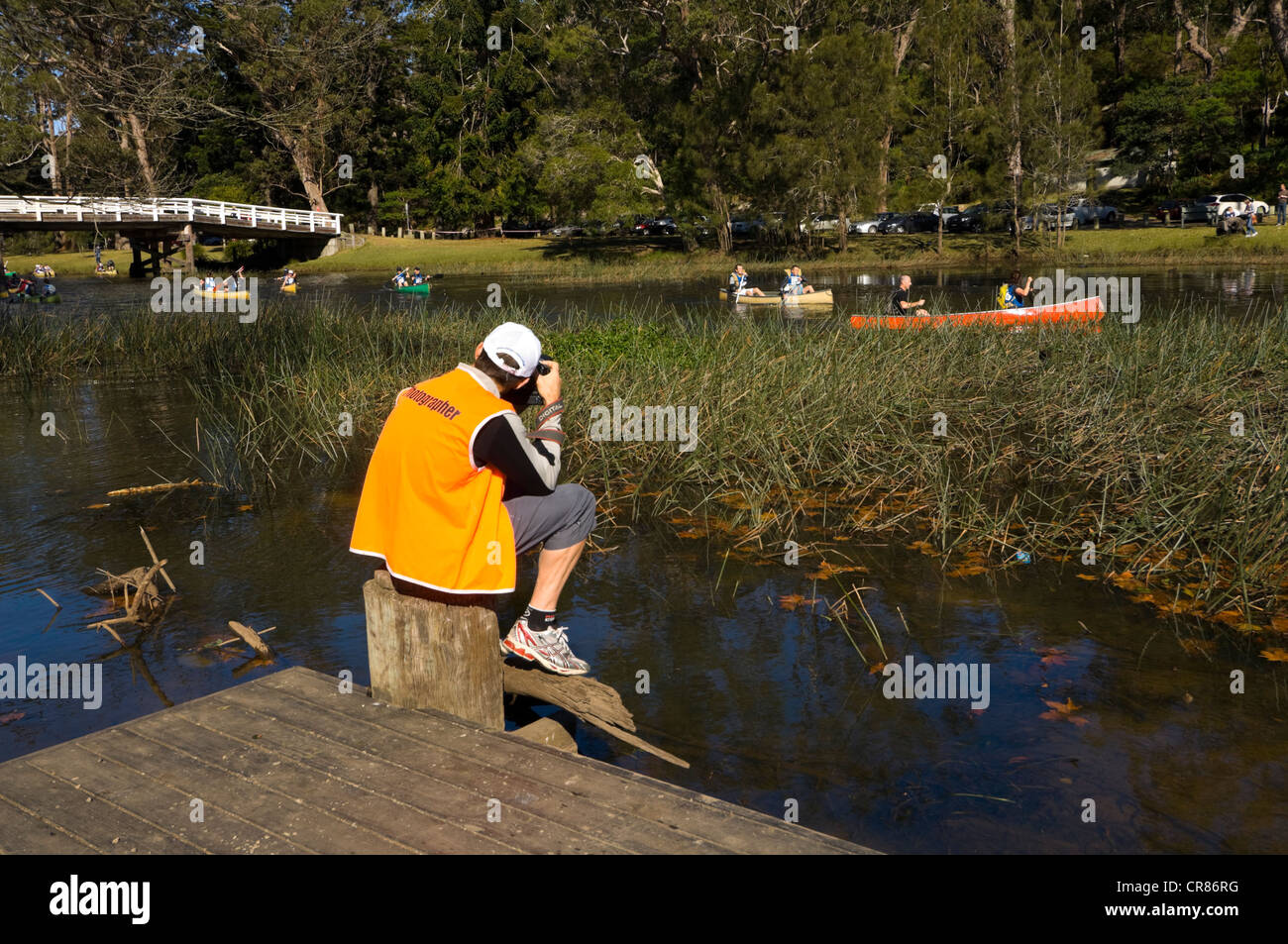 Official Photographer taking pictures of a canoeing competition, Royal National Park, NSW, Australia Stock Photo