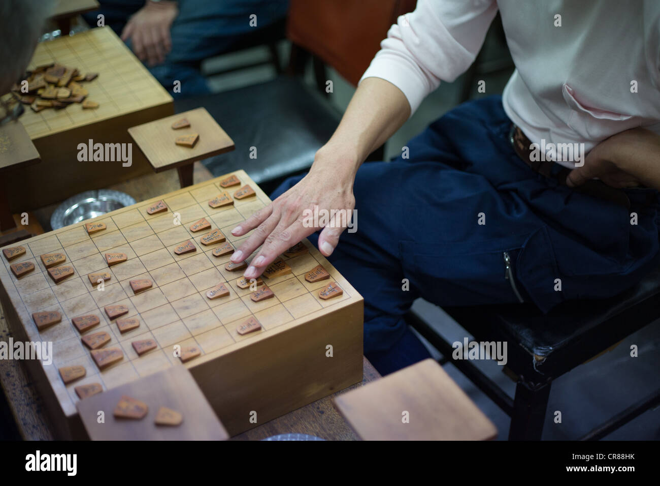 Playing shogi boardgame in a shogi parlor, in Shinsekai district, in Osaka, Kansai region, Japan Stock Photo
