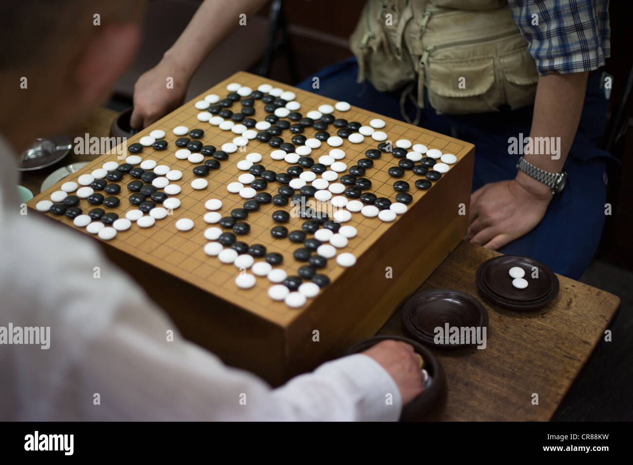 Playing shogi boardgame in a shogi parlor, in Shinsekai district, in Osaka, Kansai region, Japan Stock Photo