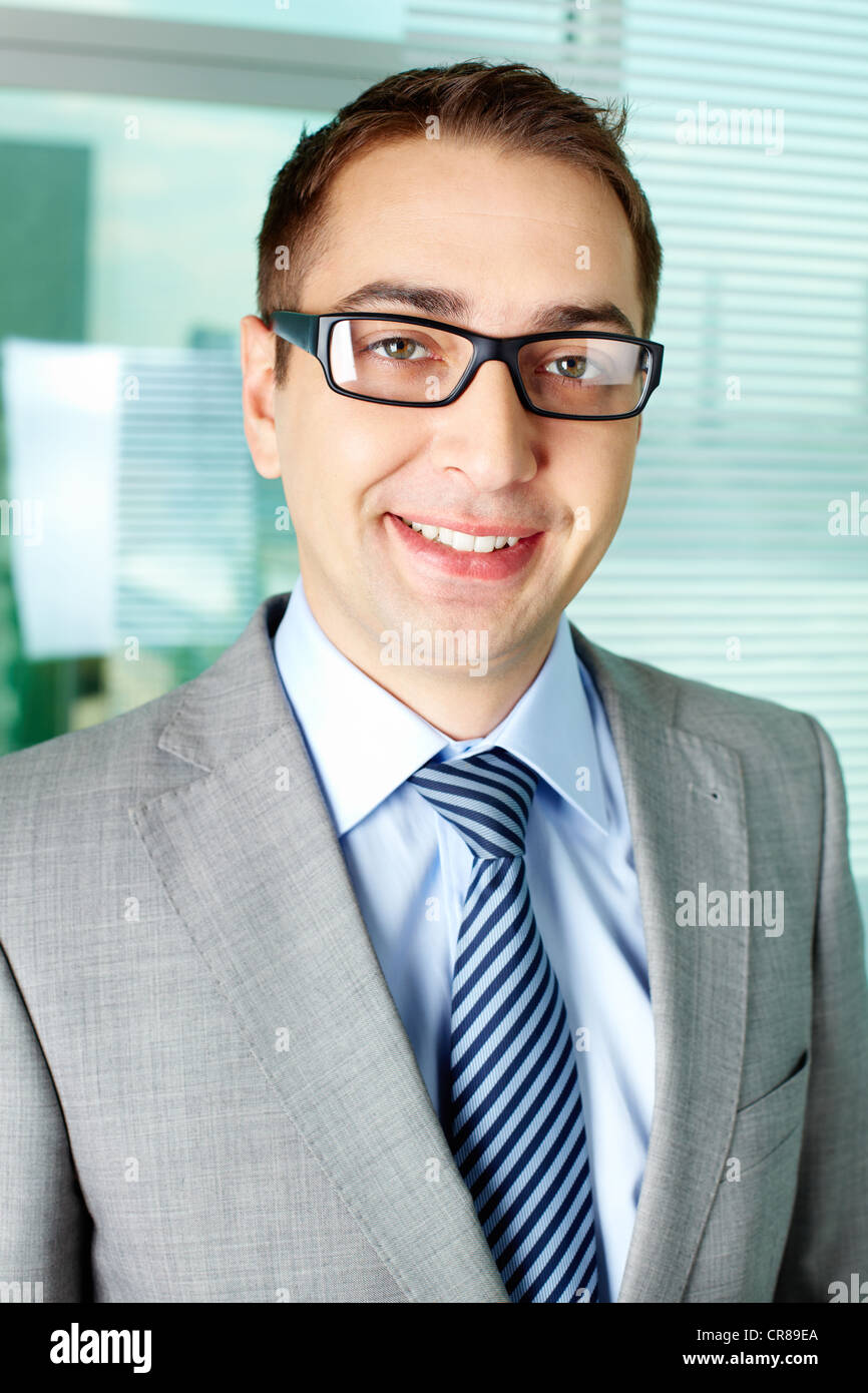 Smart businessman looking at camera and smiling Stock Photo - Alamy