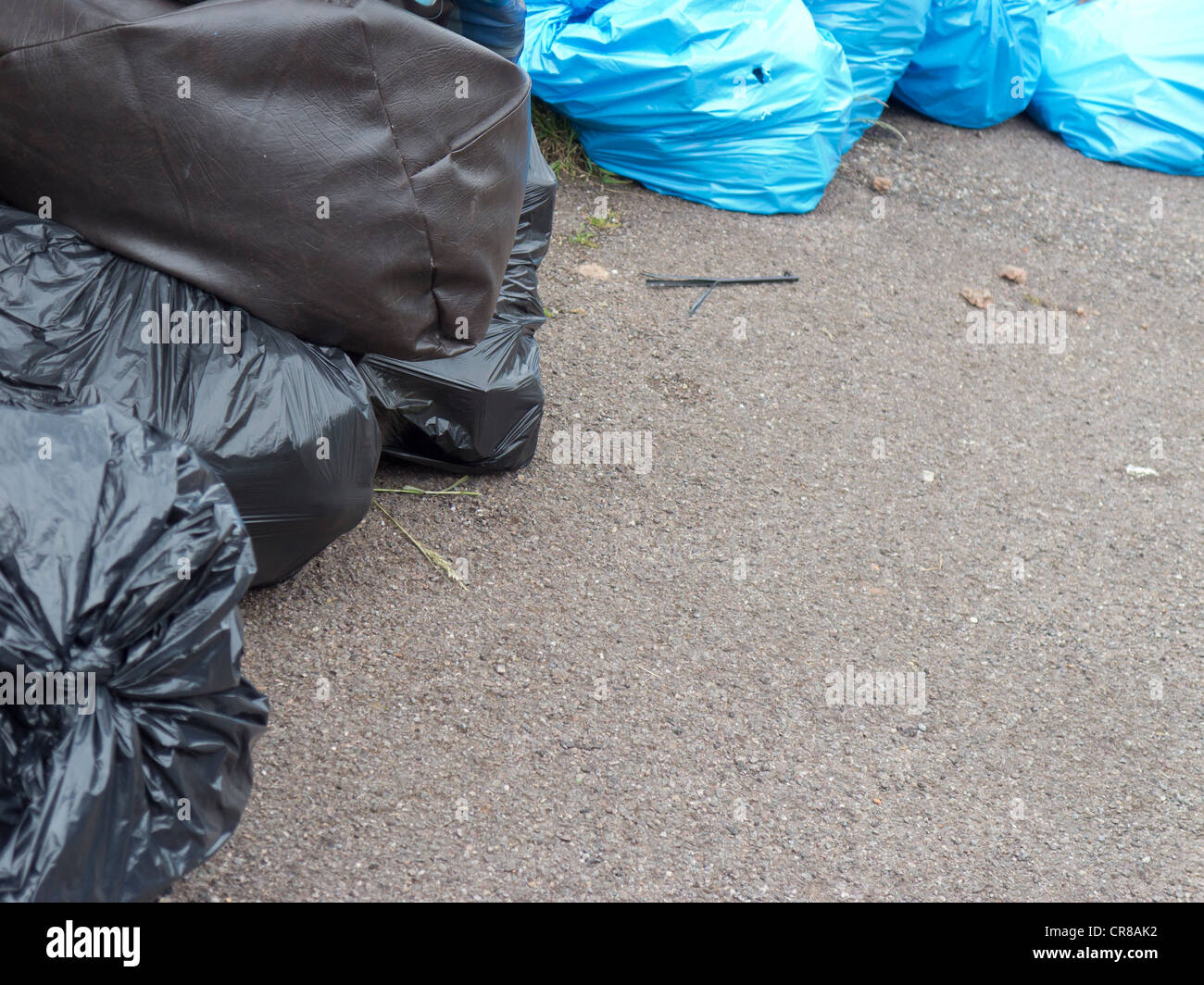 Rubbish bags await collection on the pavement Stock Photo Alamy