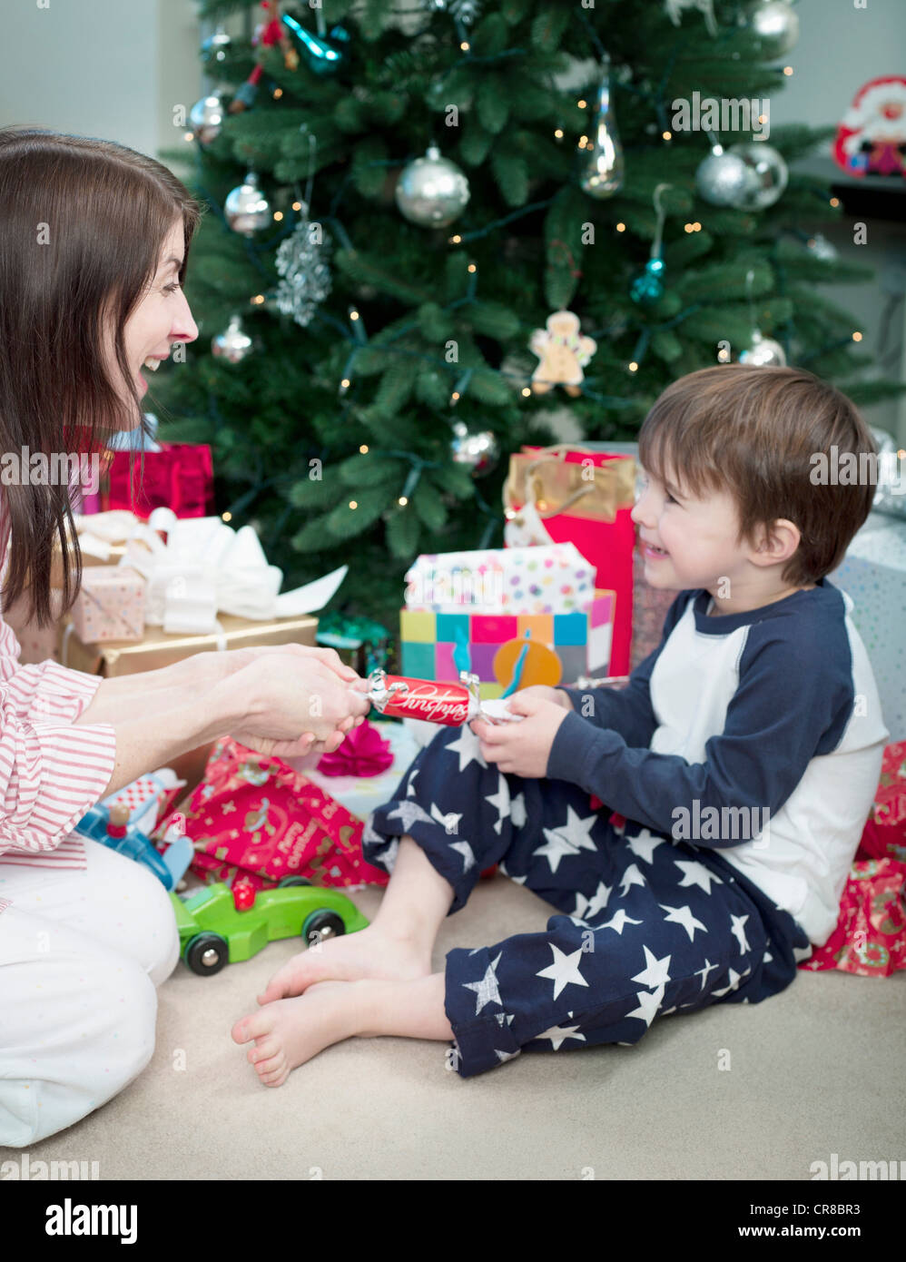 Mother and son pulling christmas cracker Stock Photo