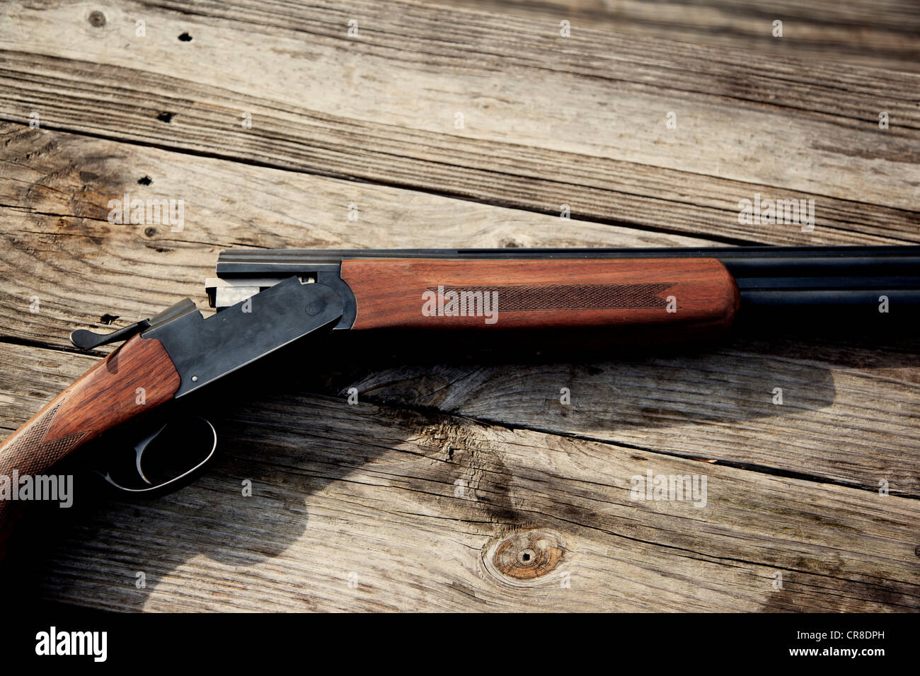 Shotgun against wood Stock Photo - Alamy