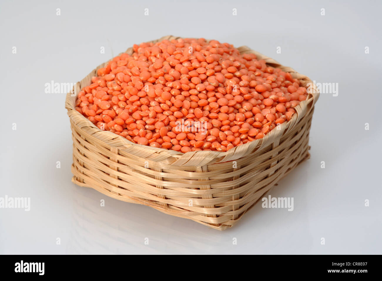 Red lentils (Lens culinaris), in a basket Stock Photo