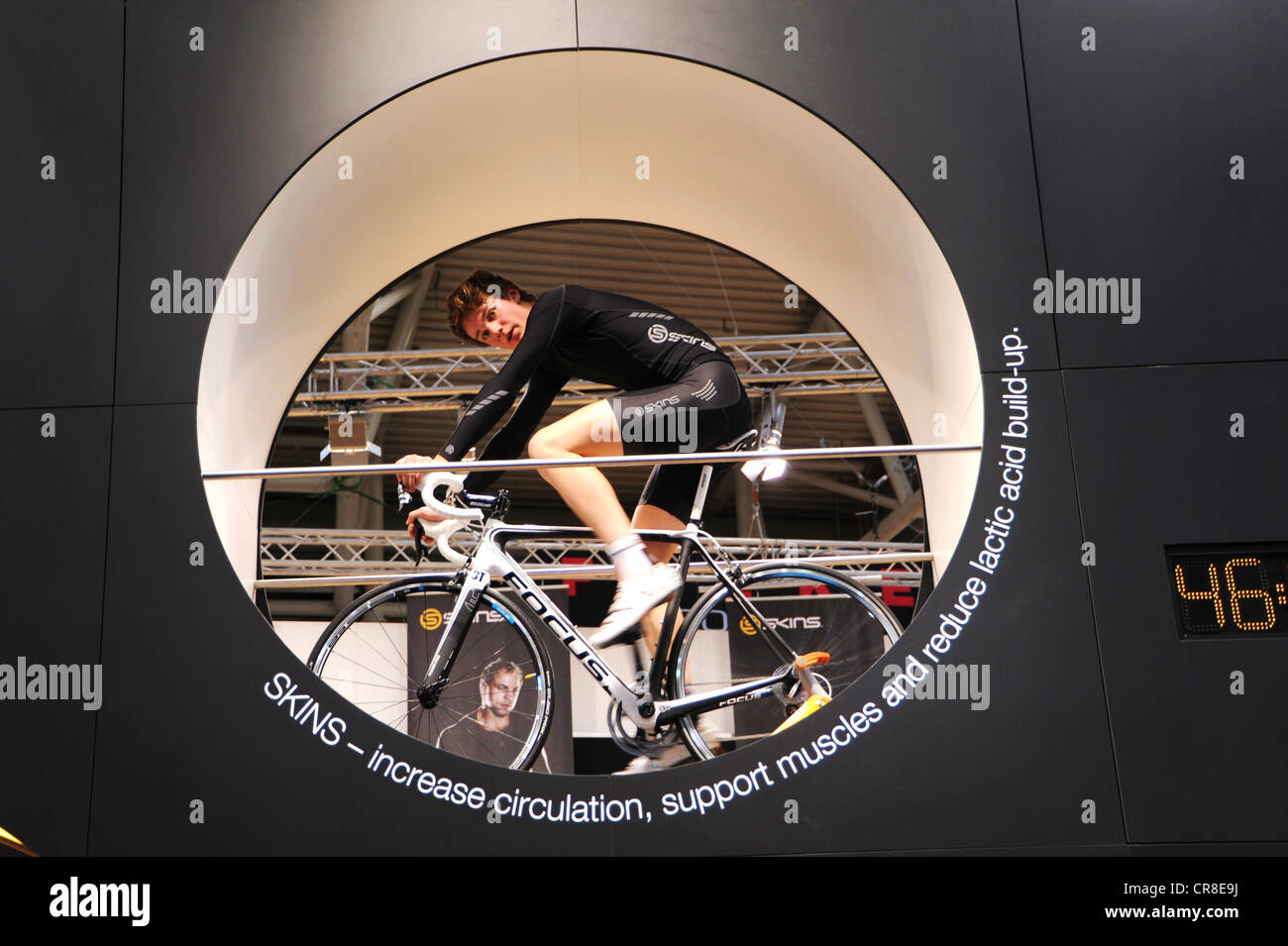 Cyclist at the exhibition booth of Skins, ISPO, International Sports Business Network, a trade fair for sports equipment and Stock Photo