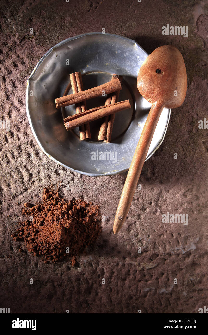 Assortment of natural spices on vintage spoons on dark slate