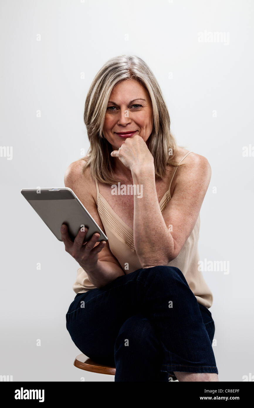 Mature woman holding digital tablet Stock Photo