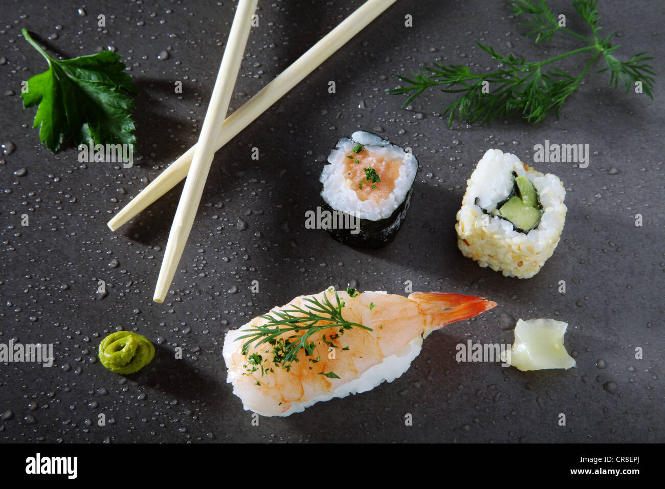 Assorted sushi with ginger and wasabi on a stone surface Stock Photo