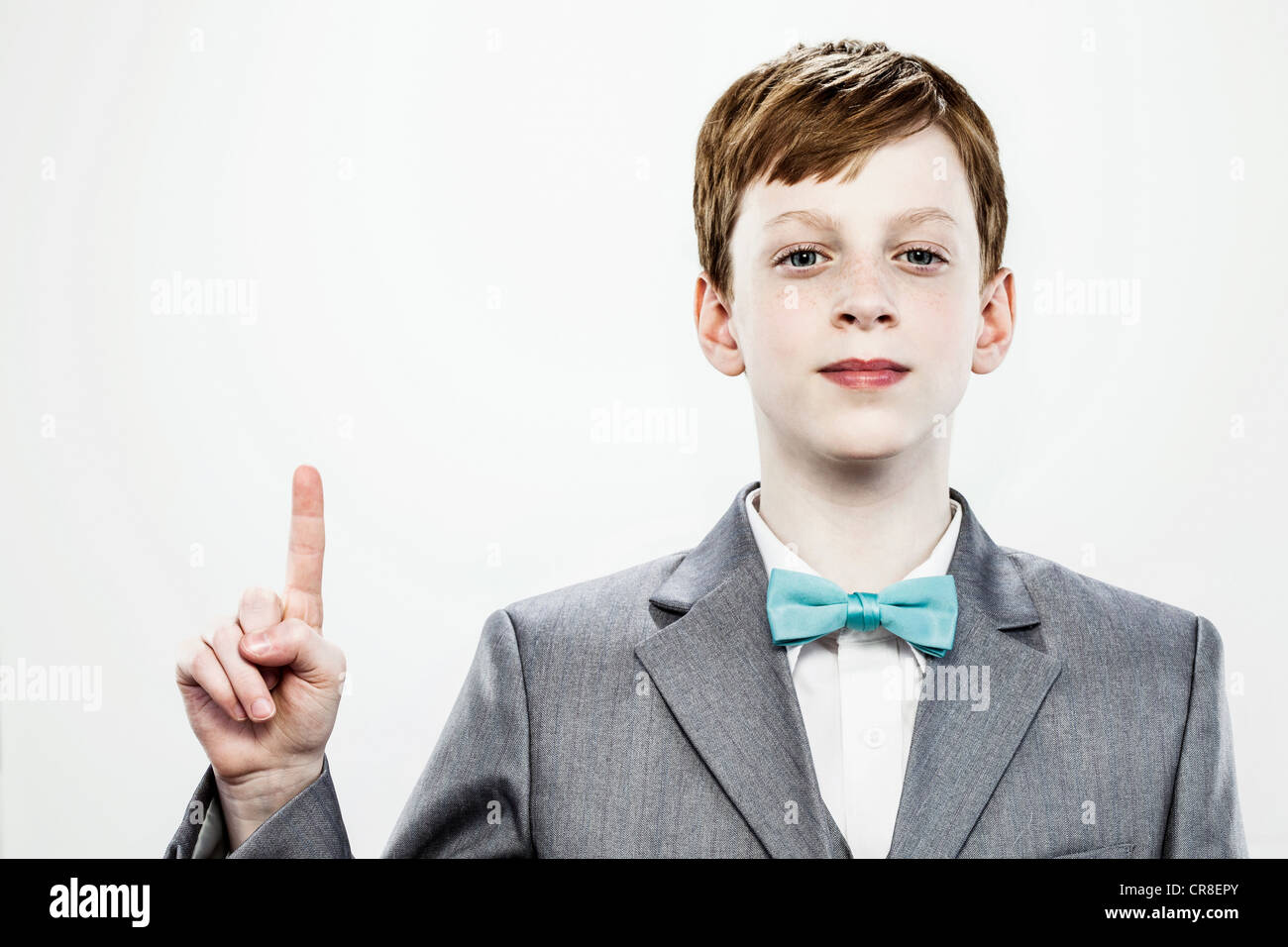 Boy pointing upwards with index finger Stock Photo