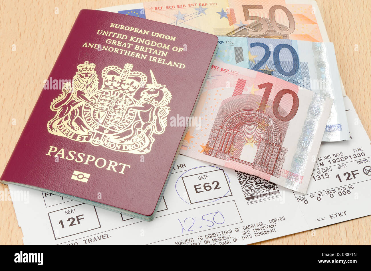 UK passport with Euro currency notes and an airline boarding card - studio shot Stock Photo