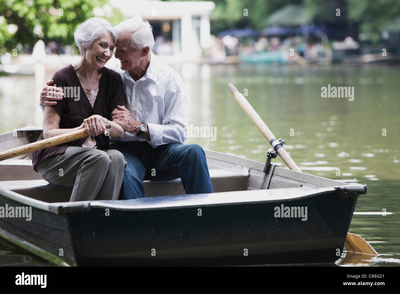Senior couple embracing in rowing boat Stock Photo