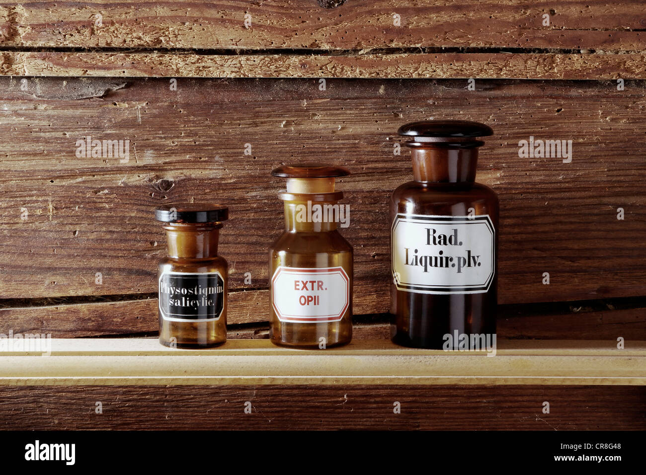 Old medicine bottles on a wooden board Stock Photo