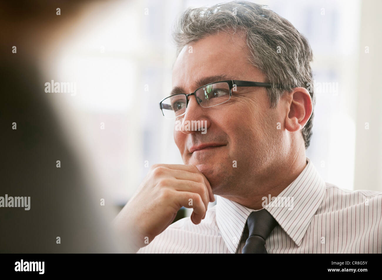 Mature businessman looking away and thinking Stock Photo
