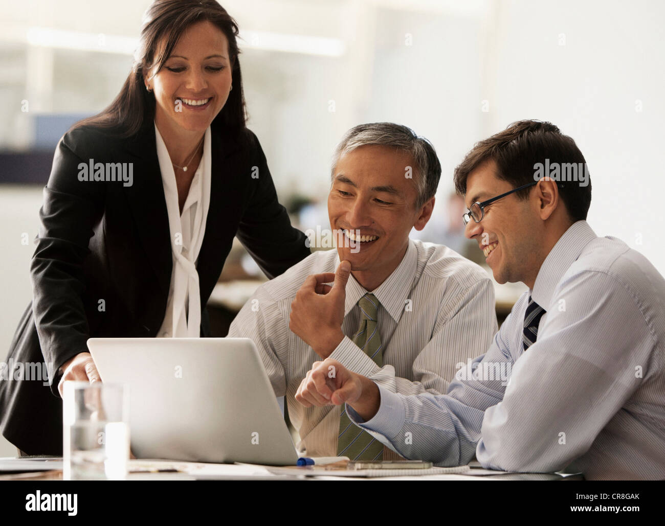 Business colleagues using laptop in office Stock Photo