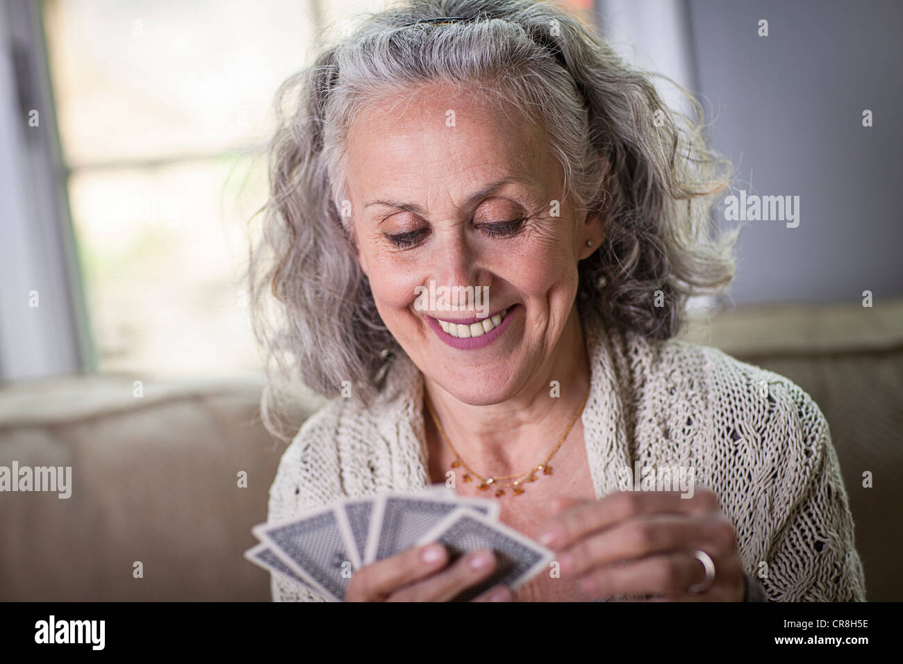 Senior woman playing card game at home Stock Photo Alamy
