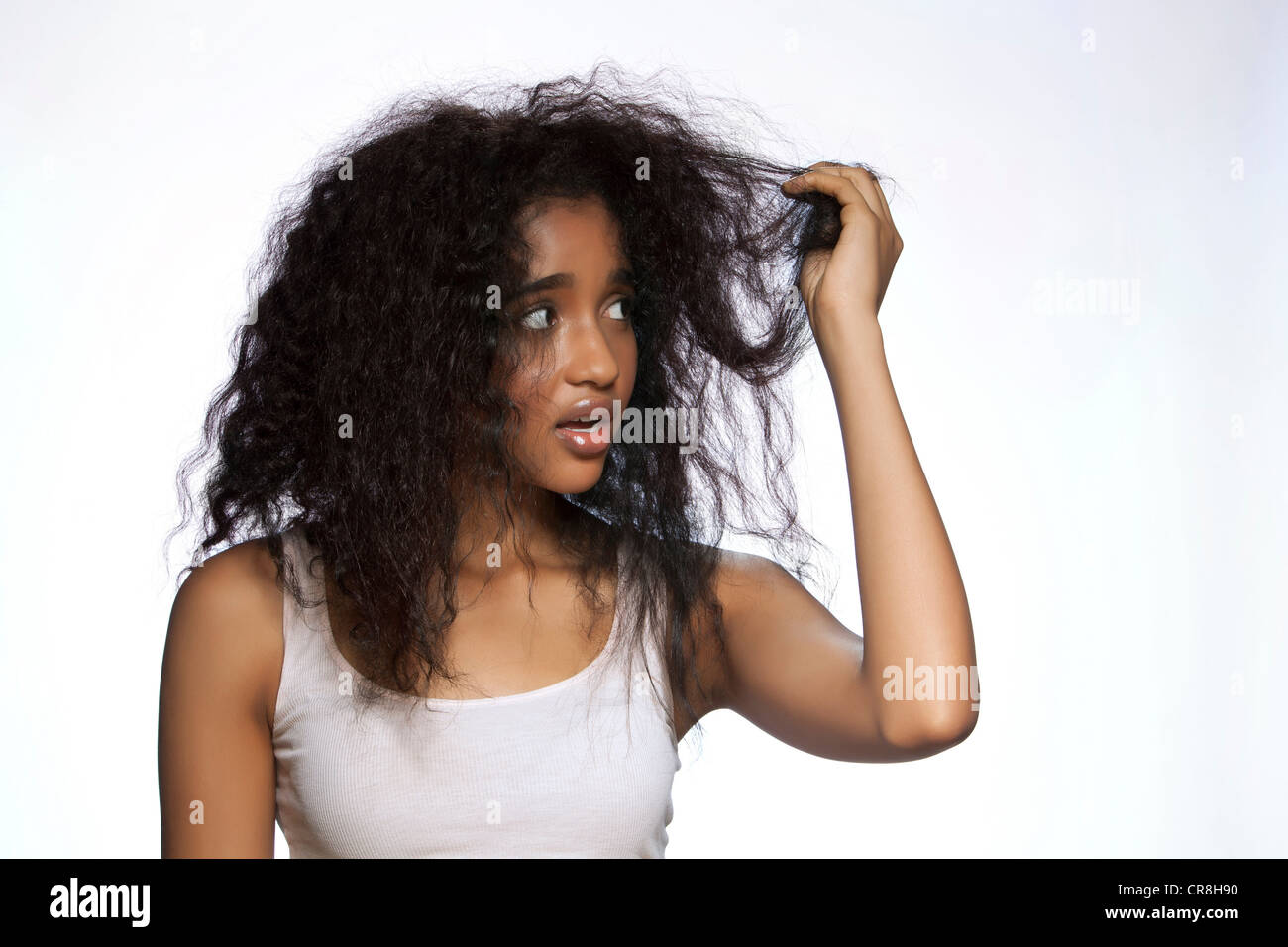 https://c8.alamy.com/comp/CR8H90/young-woman-holding-hair-against-white-background-CR8H90.jpg