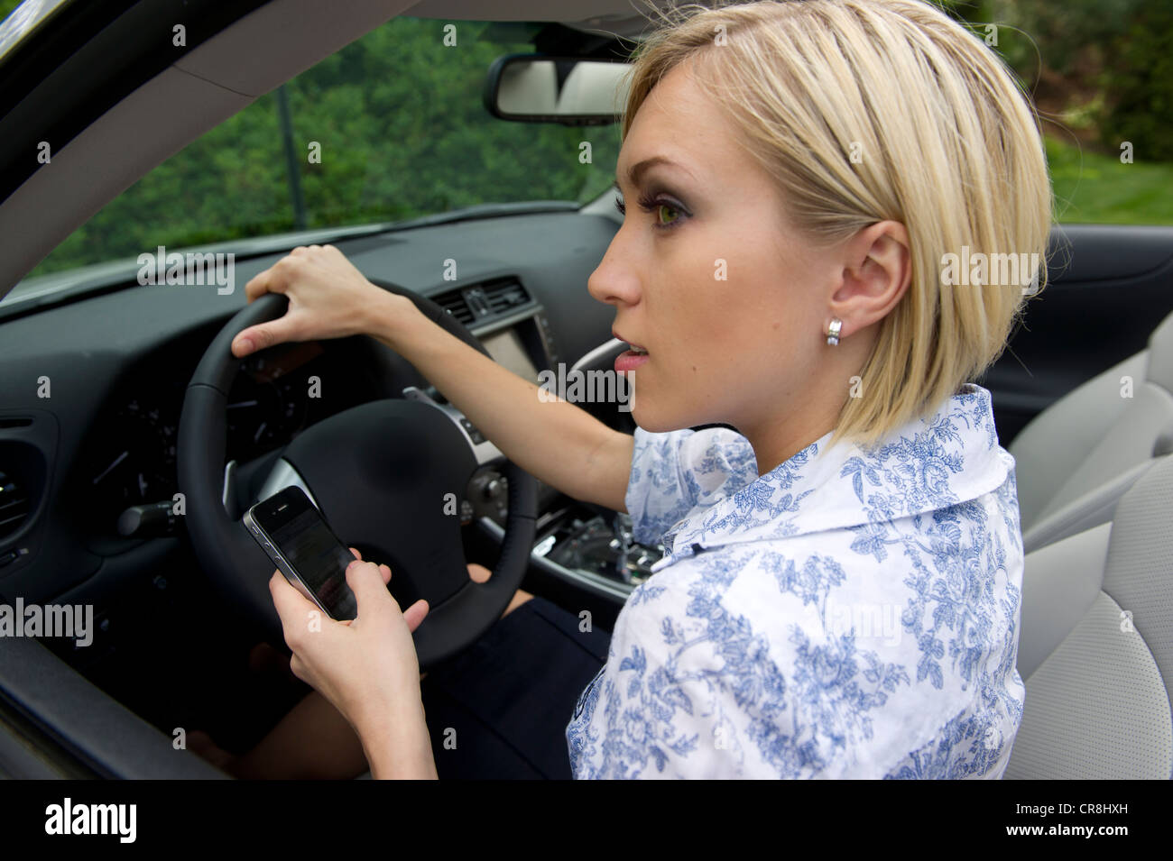 Using hand held device while driving Stock Photo Alamy