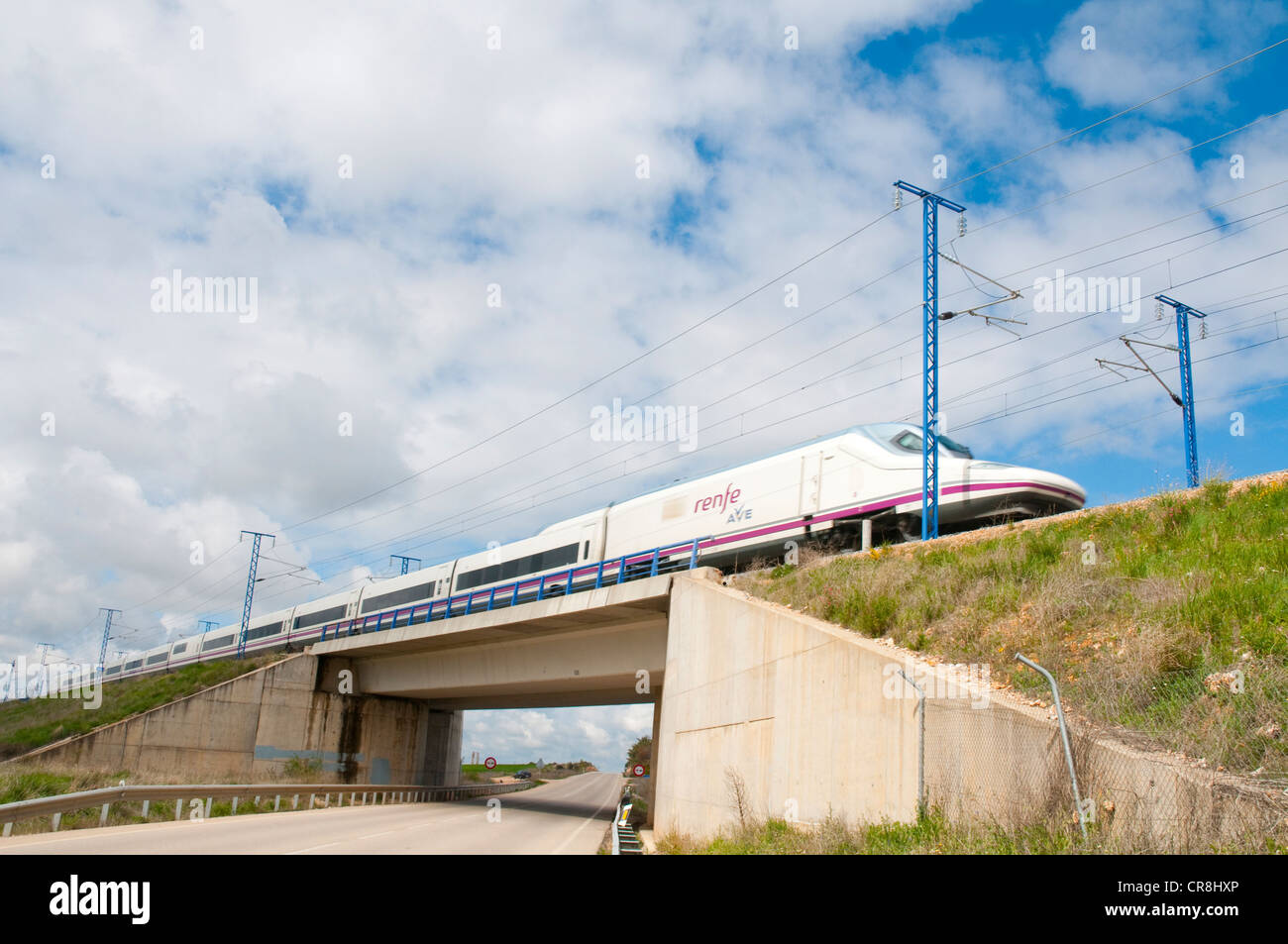 Madrid-Barcelona high-speed train traveling over a side road. La Alcarria, Guadalajara province, Castilla La Mancha, Spain. Stock Photo
