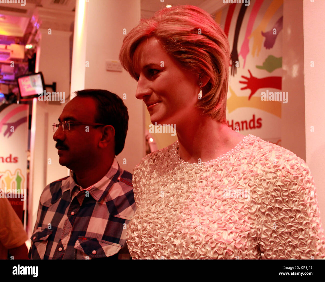 Man posing next to the wax statue of princess Diana at the madame tussauds museum Stock Photo