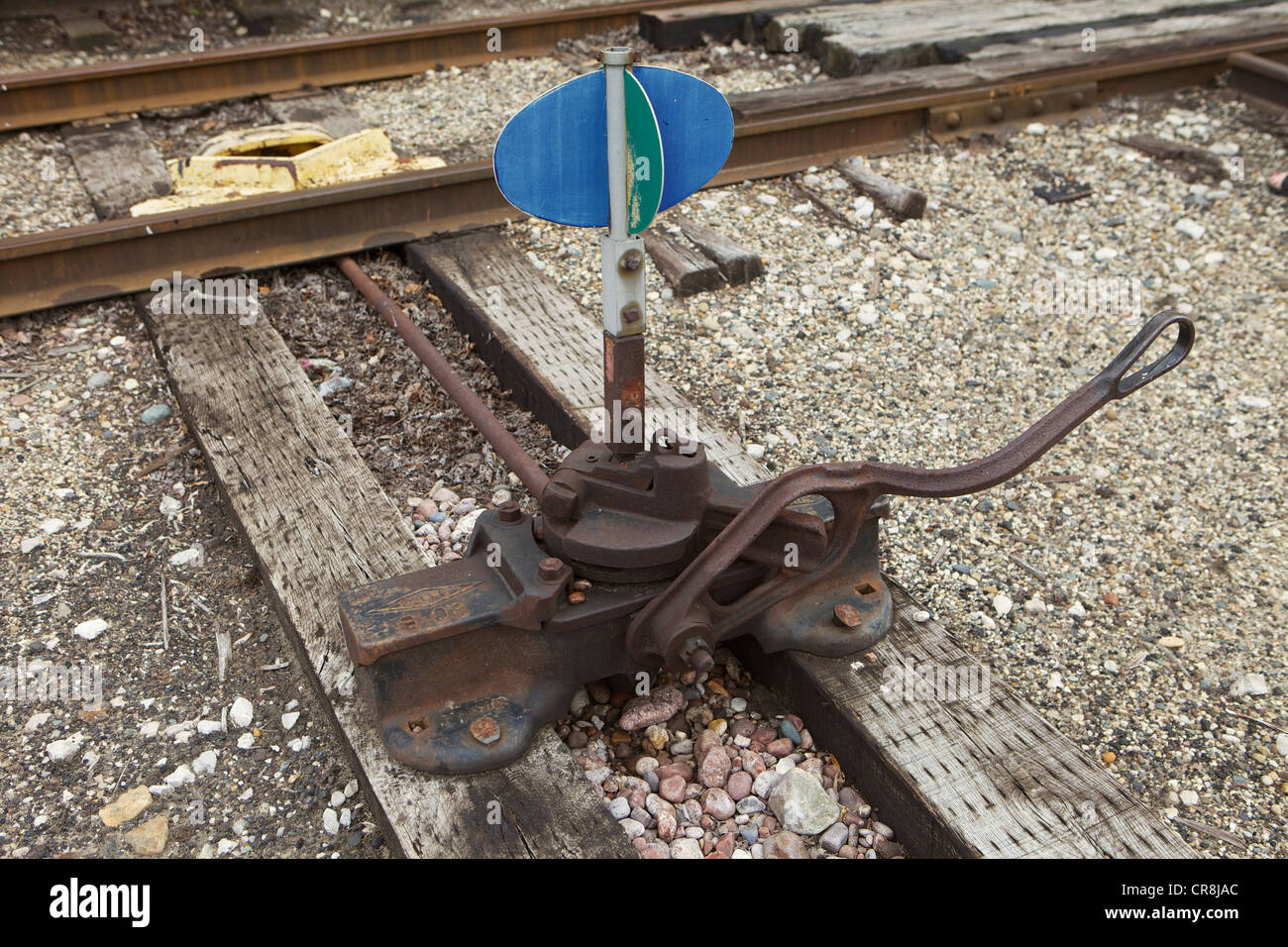 Blue and green railroad track switch stand Stock Photo