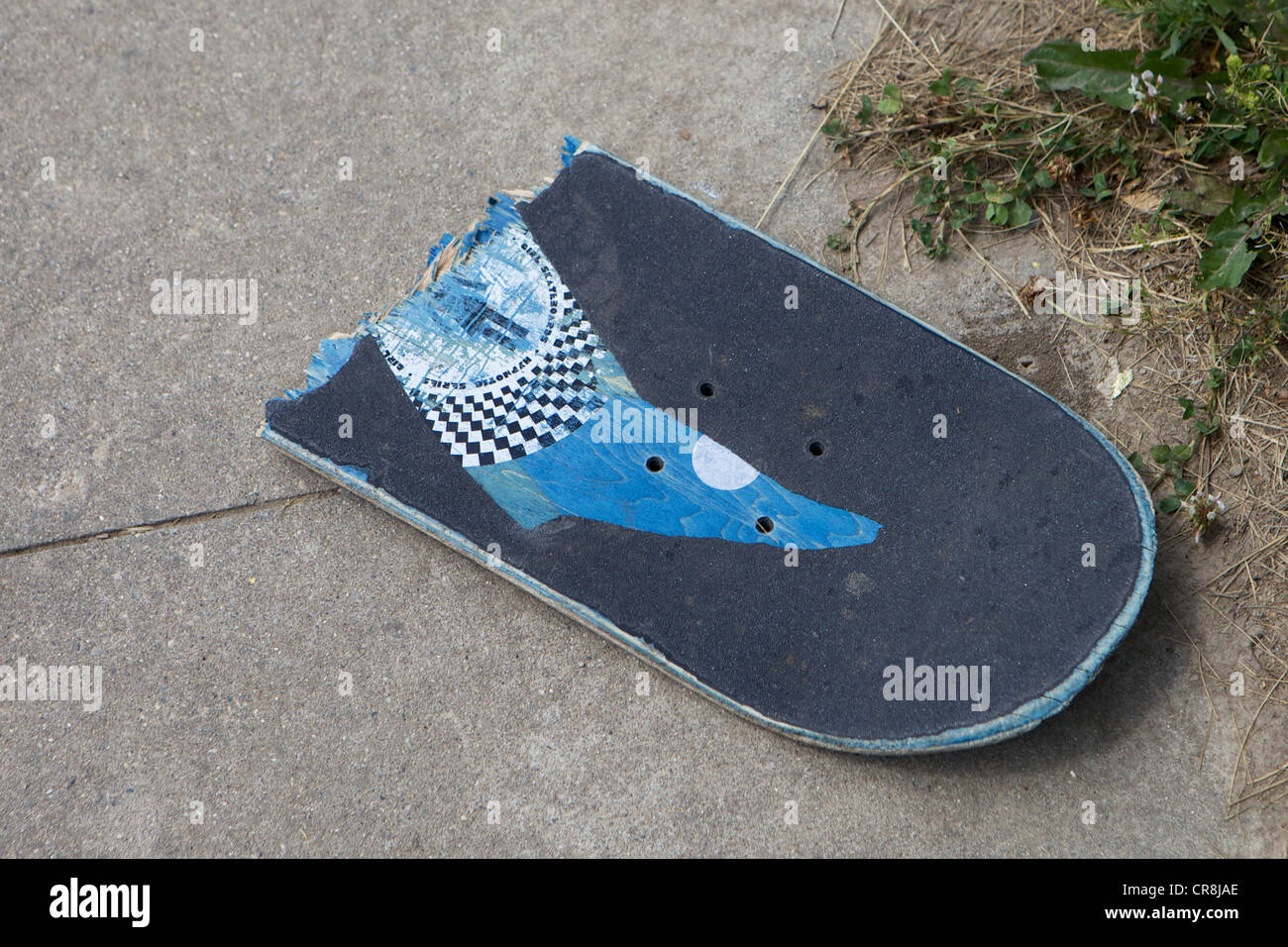 Broken Skateboard on a sidewalk Stock Photo Alamy