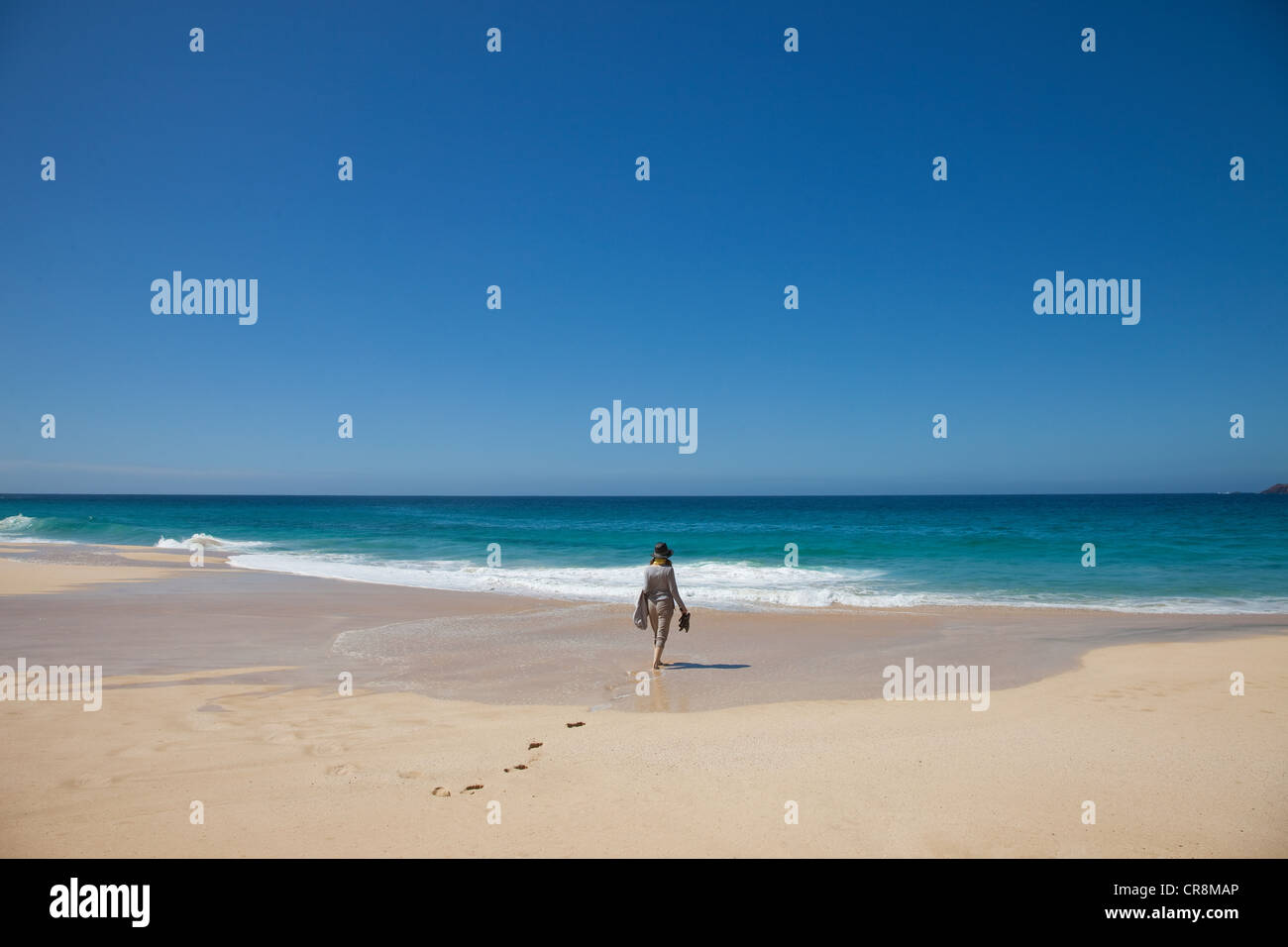 Woman walking toward beach hi-res stock photography and images - Alamy